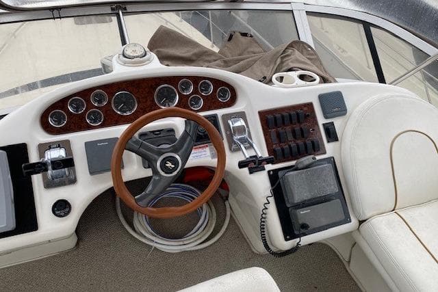 Cockpit of 1999 Sea Ray 420 Aft Cabin with steering wheel and control panel.