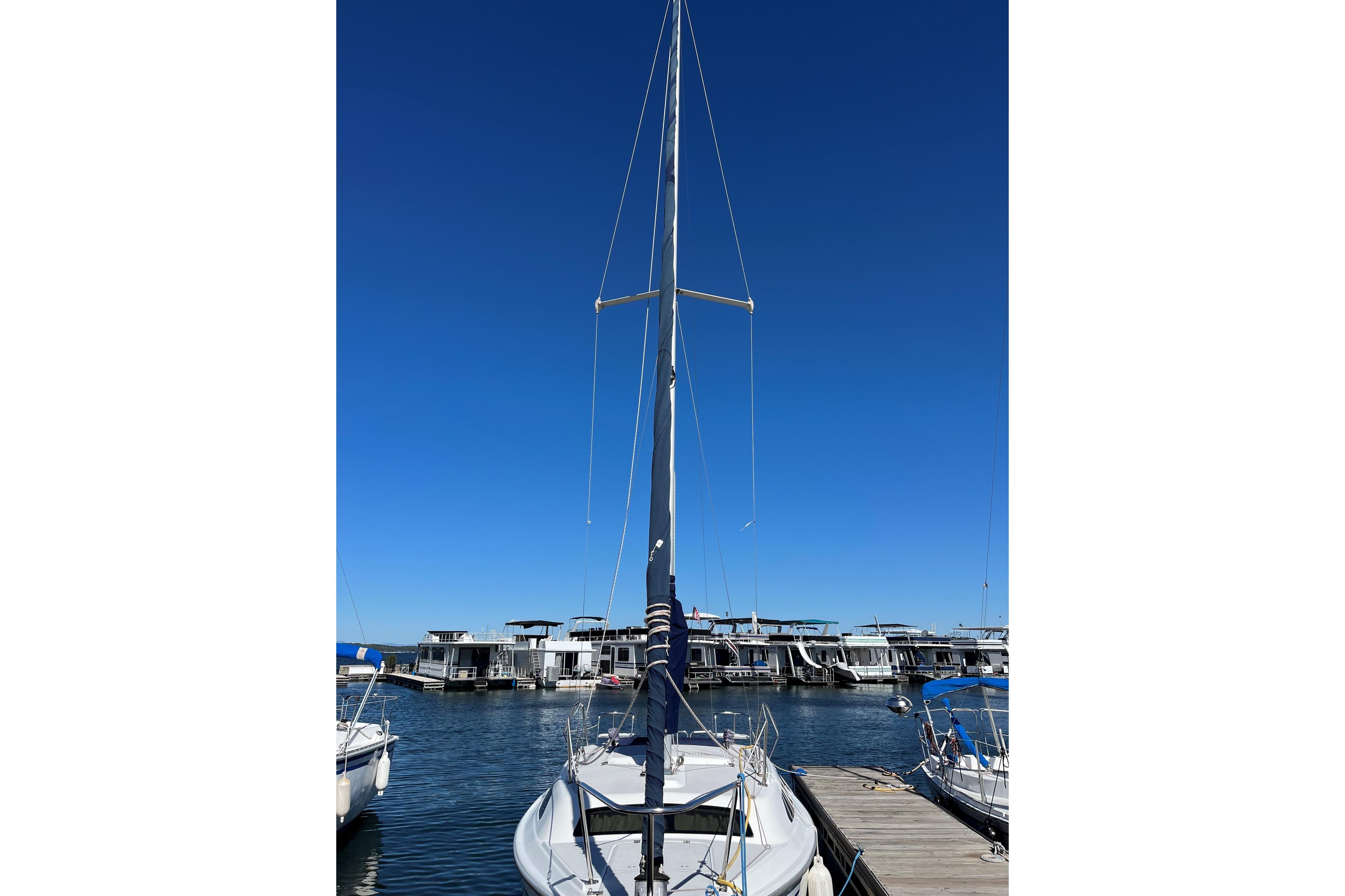 2004 Catalina 250 WK sailboat docked at marina under clear blue sky.