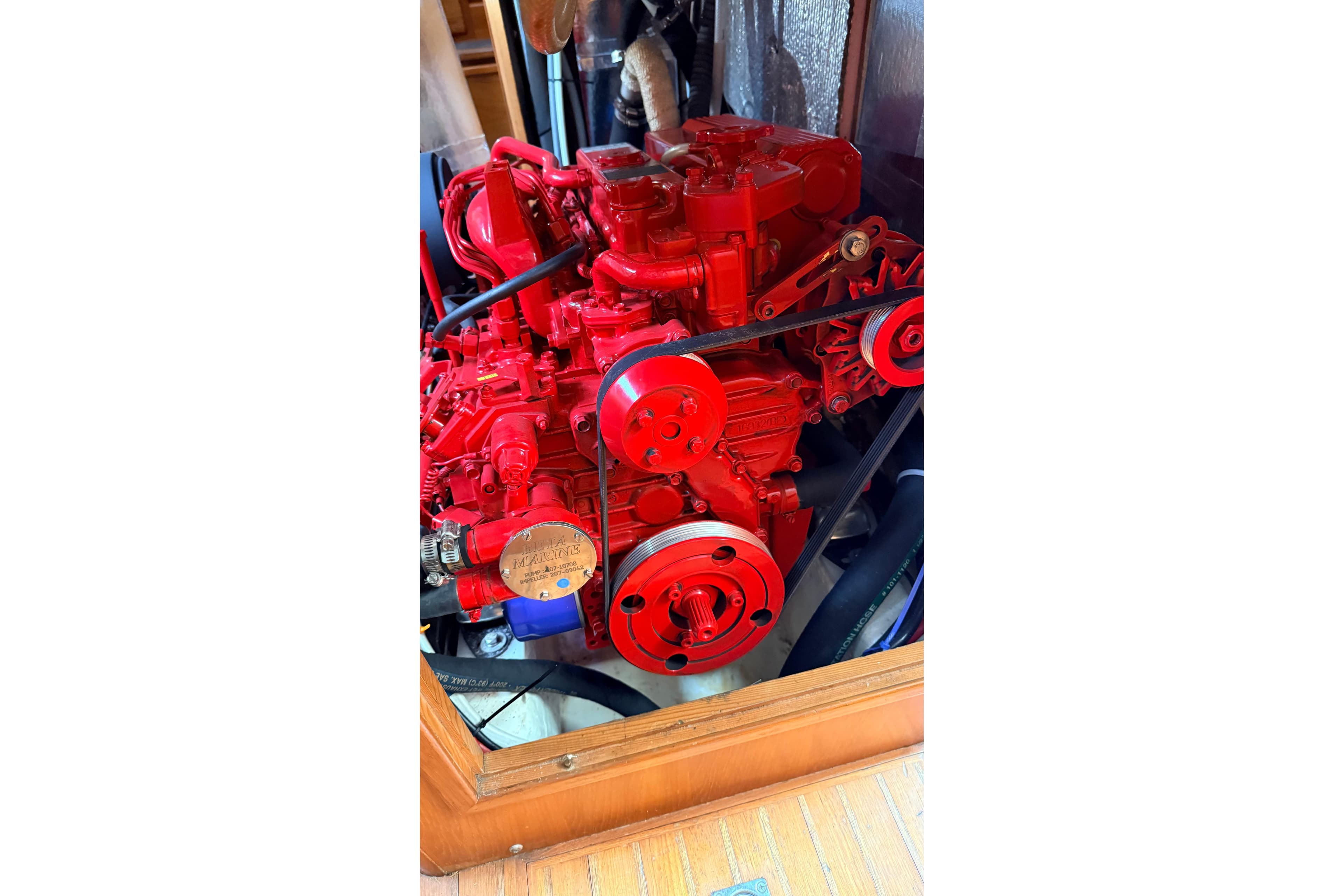 Red engine of a 1983 Tanton 44 boat, showcasing intricate mechanical details.