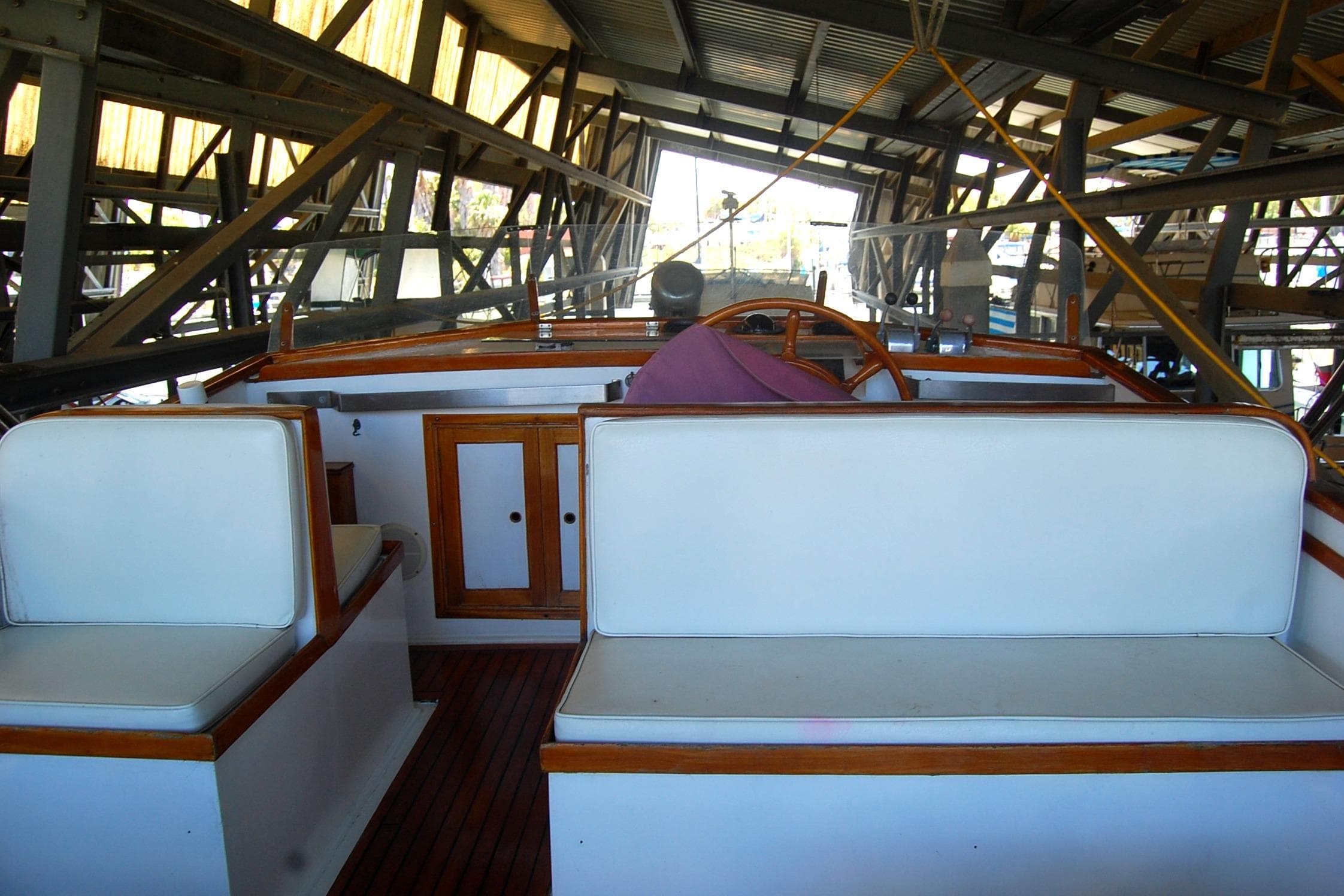 1983 Island Gypsy 36 Quad Cabin interior with white seating and wooden accents.