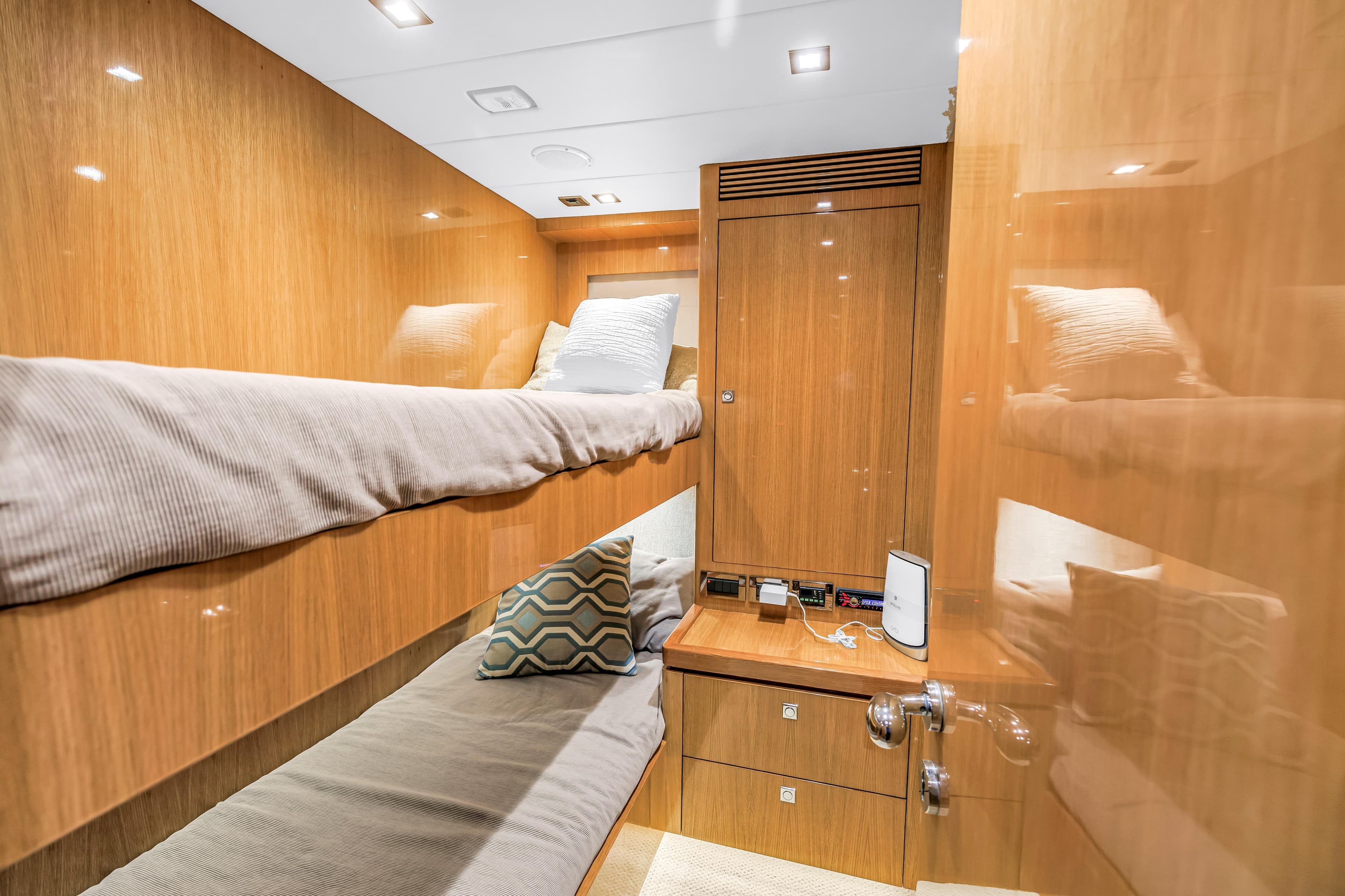 Luxurious 2015 Horizon E88 yacht cabin with wooden interior and cozy bunk beds.