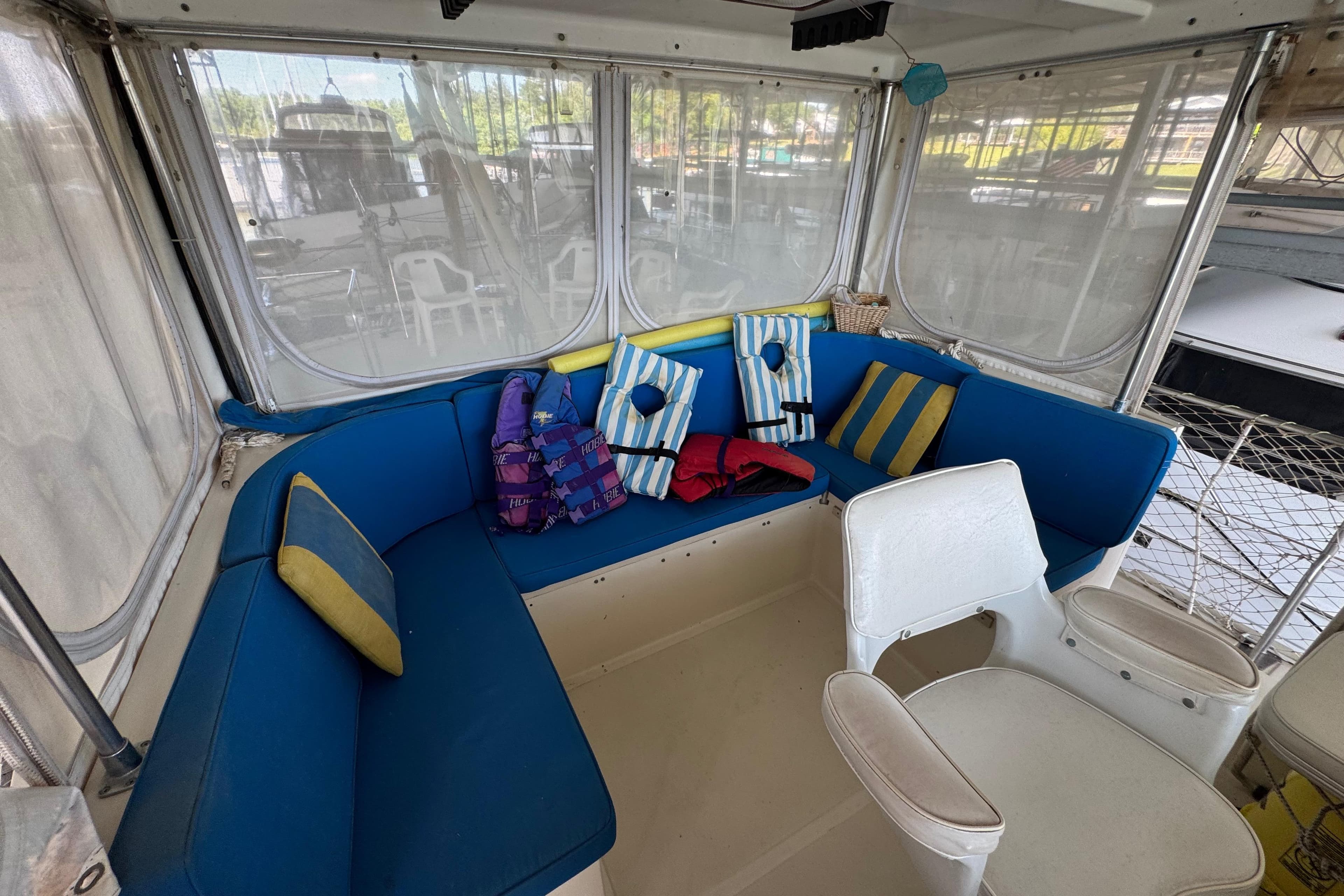 1984 Kadey-Krogen 36 Manatee interior with blue seating and striped cushions.