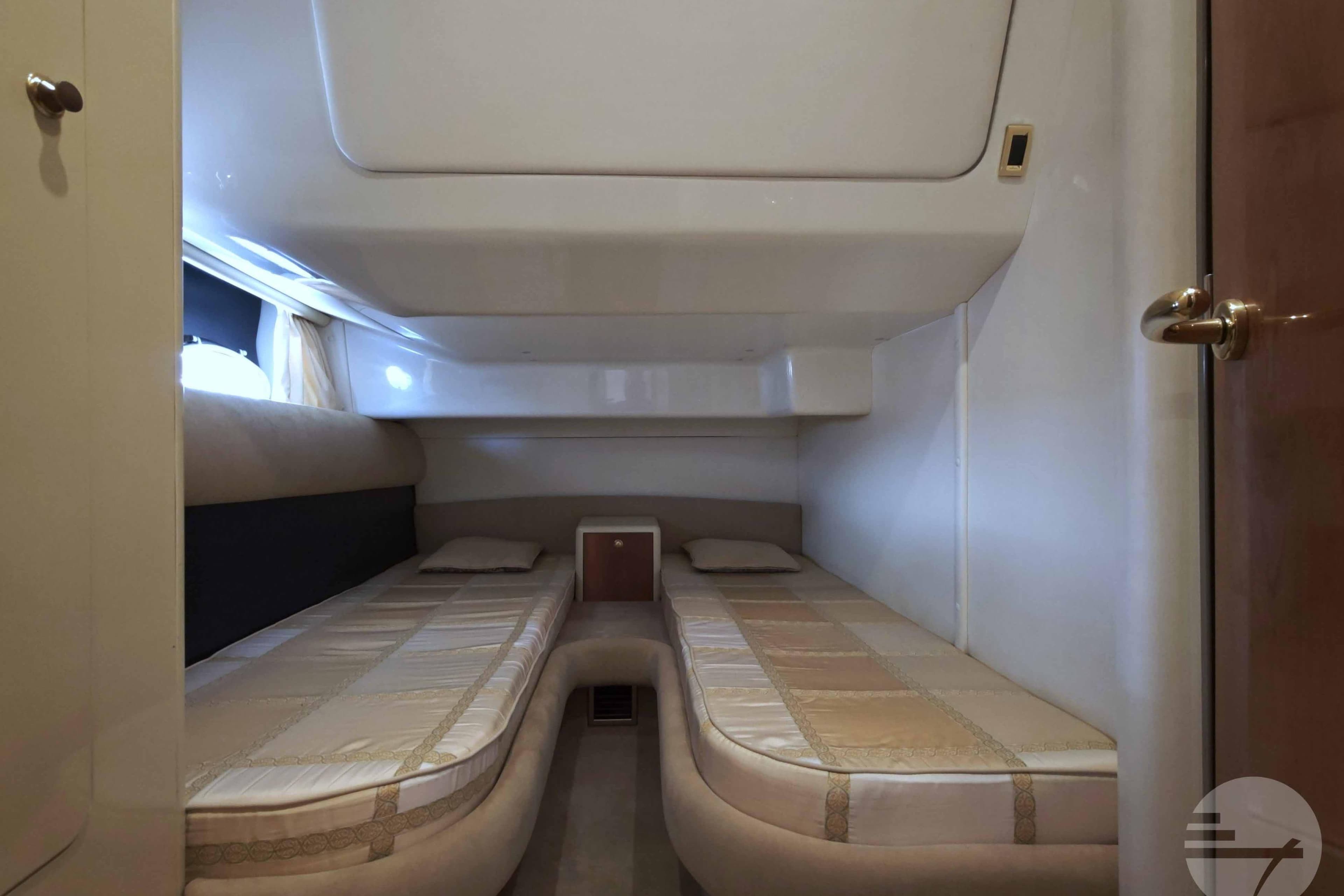 Interior cabin of 2007 Cranchi Atlantique 40 yacht with twin beds and modern design.