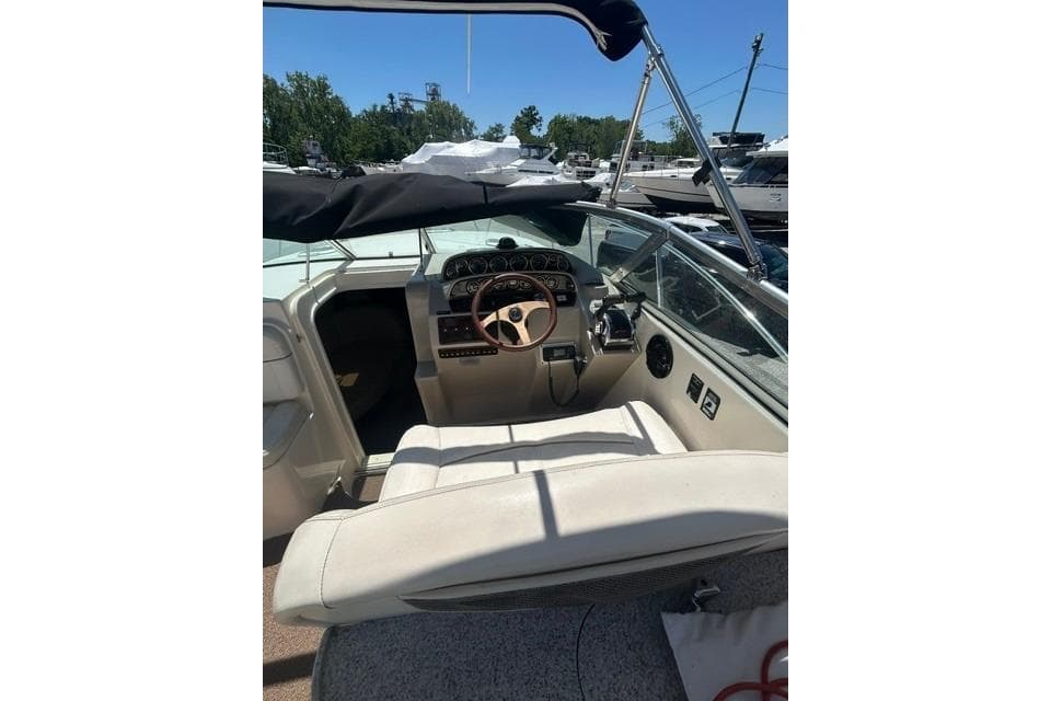 2001 Rinker 310 Express Cruiser cockpit with steering wheel and dashboard controls.