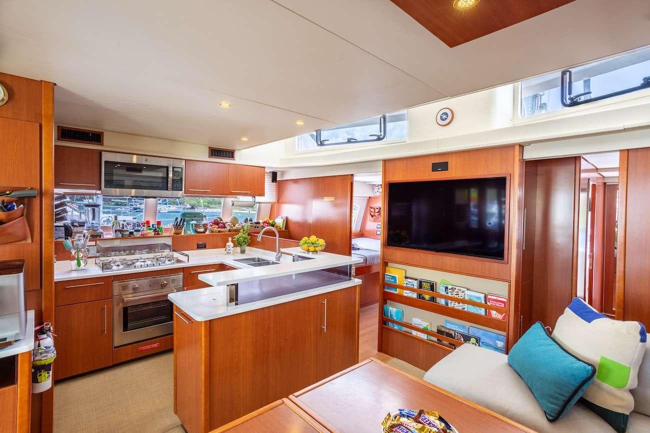 Luxurious interior of 2014 Leopard 58 yacht with modern kitchen and cozy seating area.
