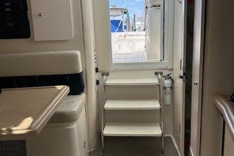Interior view of 2001 Wellcraft 330 Coastal boat with steps leading outside.