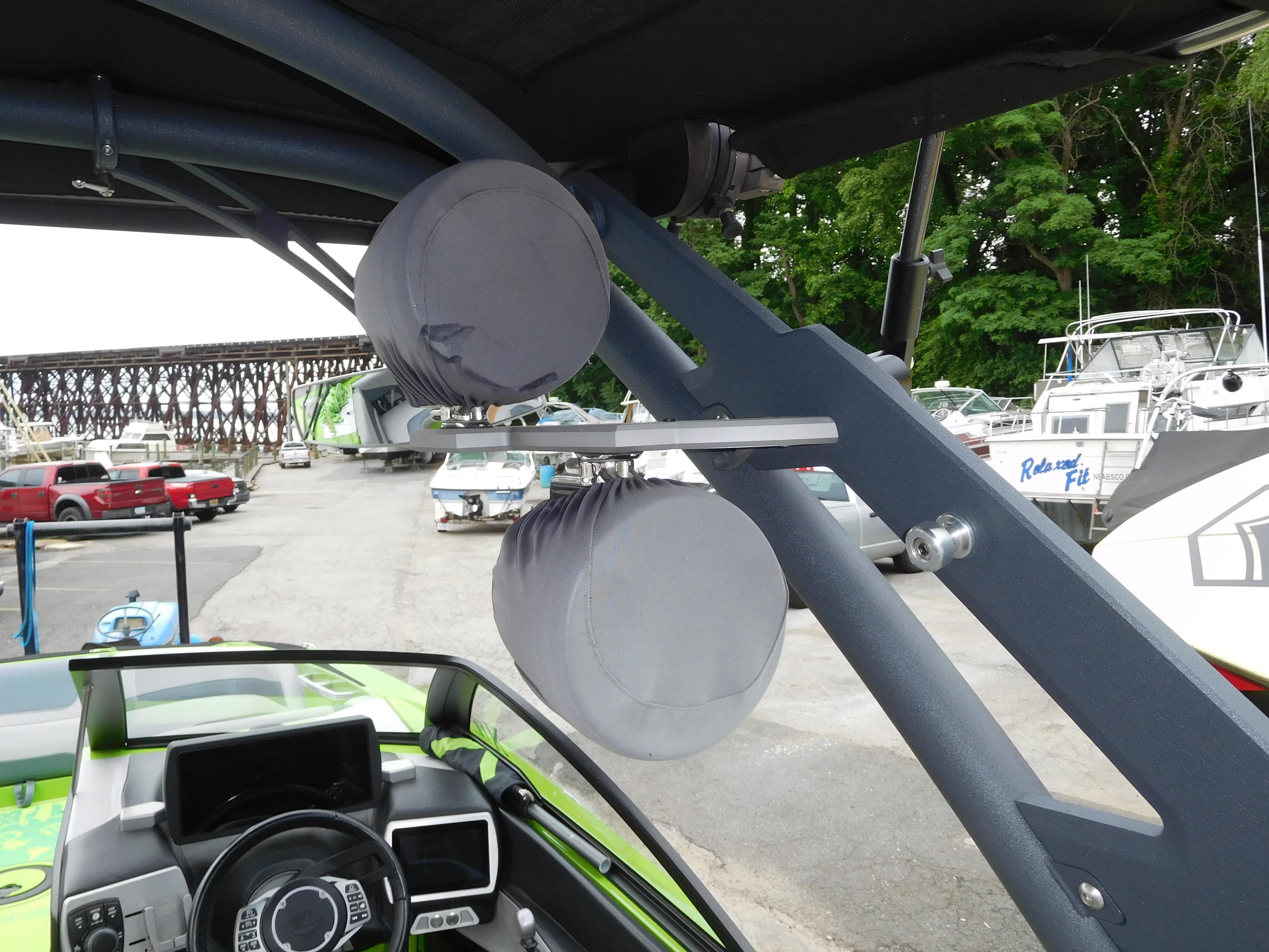 2017 Malibu Wakesetter 24 MXZ boat with mounted speakers in a marina.
