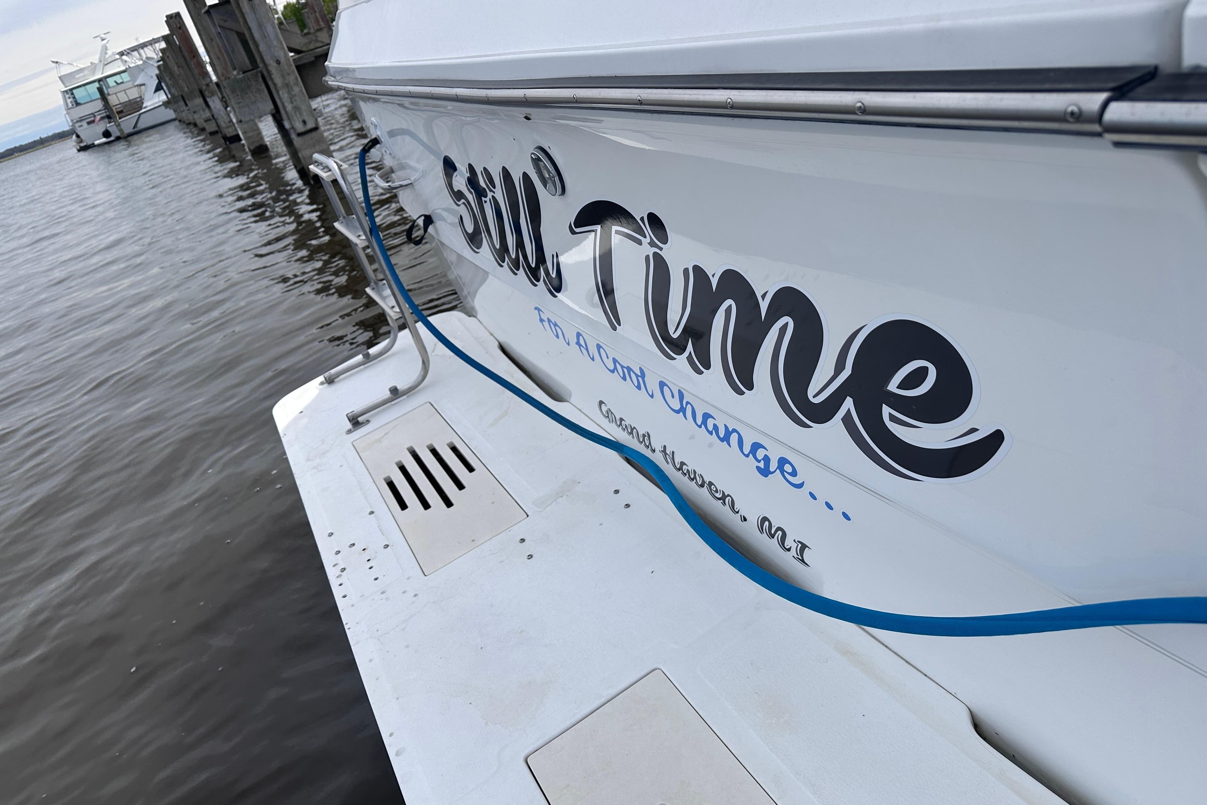1989 Sea Ray 390 Express Cruiser docked, featuring "Still Time" name on hull.