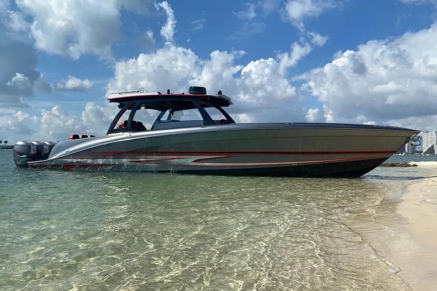 Luxury Concept 44' Open Deck boat, 2021 model, anchored on a sandy beach under a blue sky.