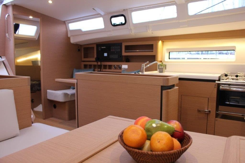 Modern interior of 2024 Jeanneau Sun Odyssey 490 yacht with fruit basket.