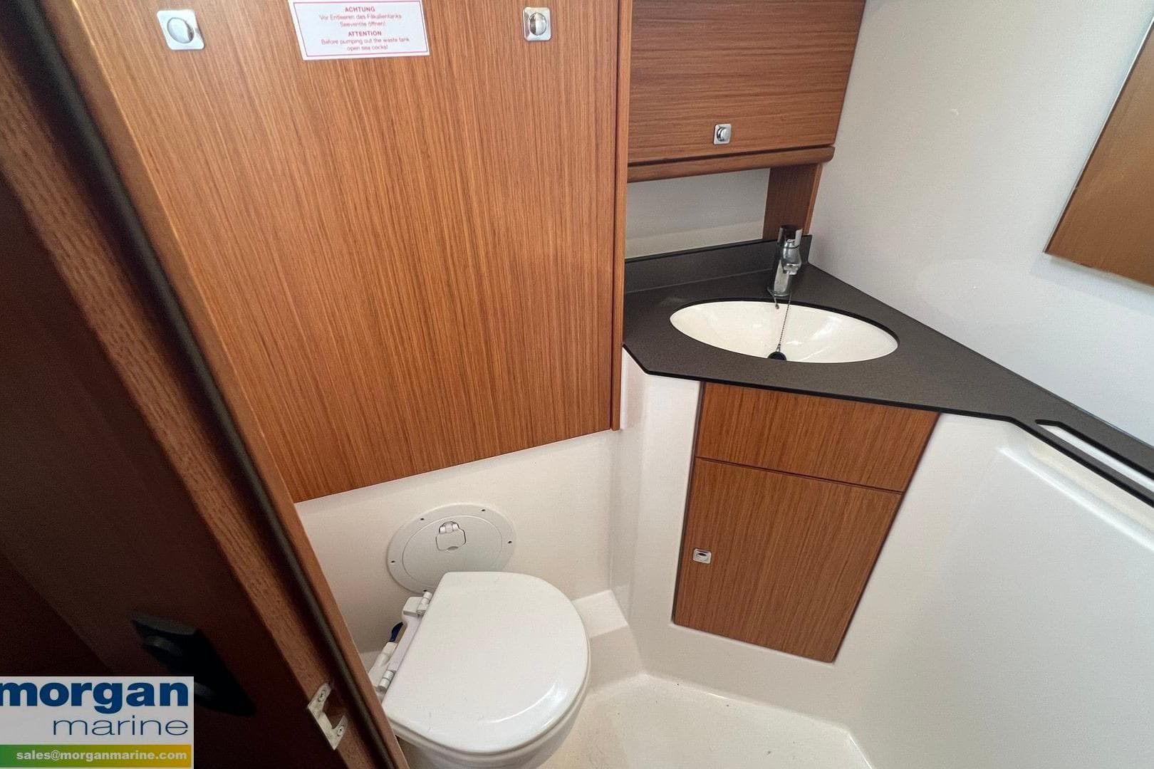 2015 Bavaria Cruiser 46 bathroom with wooden cabinetry and modern sink design.