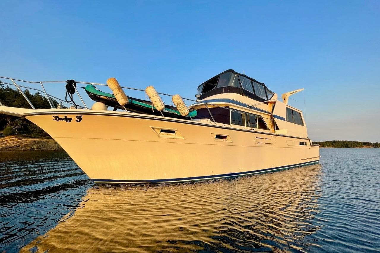 1987 Californian 55 Cockpit Motor Yacht on calm water at sunset.