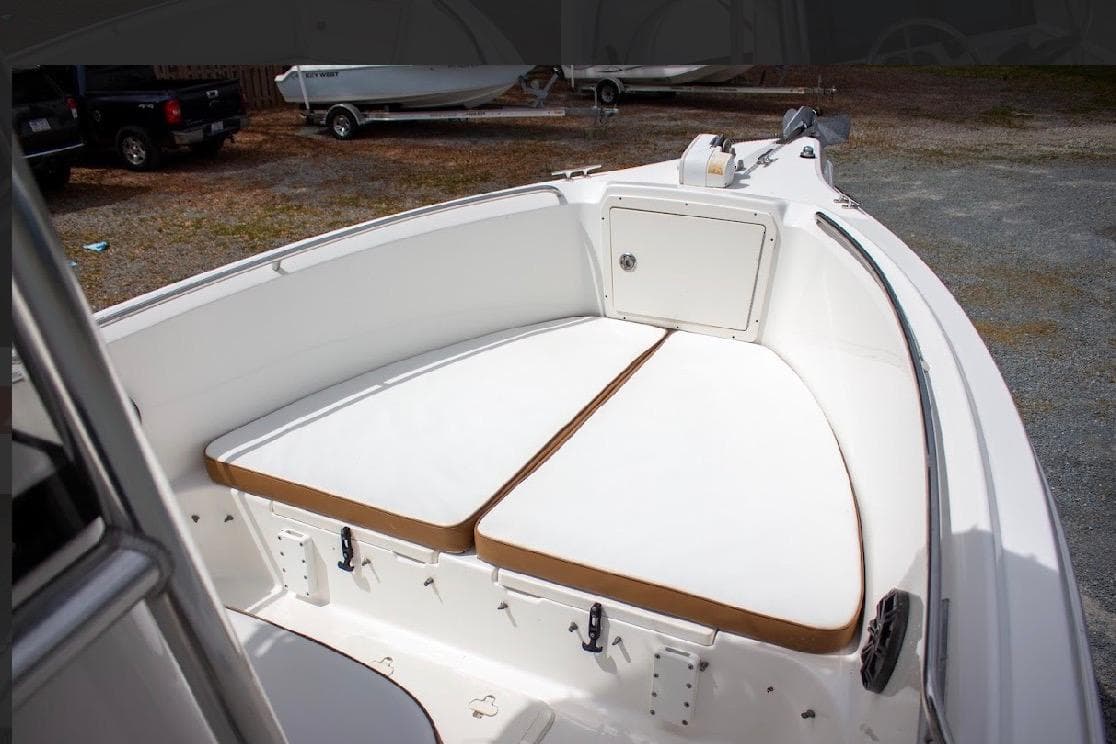 2001 Cobia 274 Center Console boat interior with cushioned seating and storage compartment.
