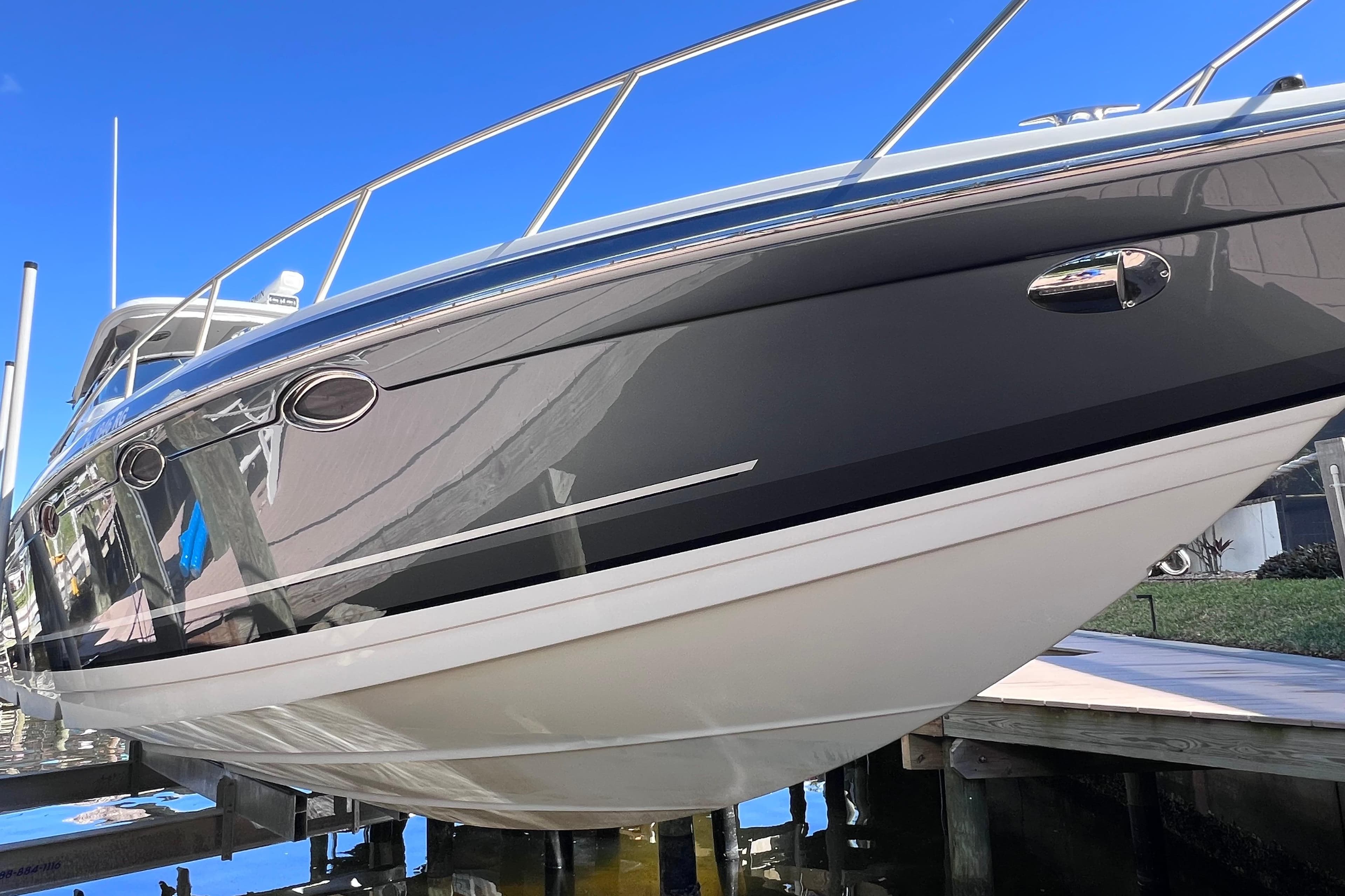 2017 Formula 370 Super Sport boat on lift, sleek design, blue sky background.