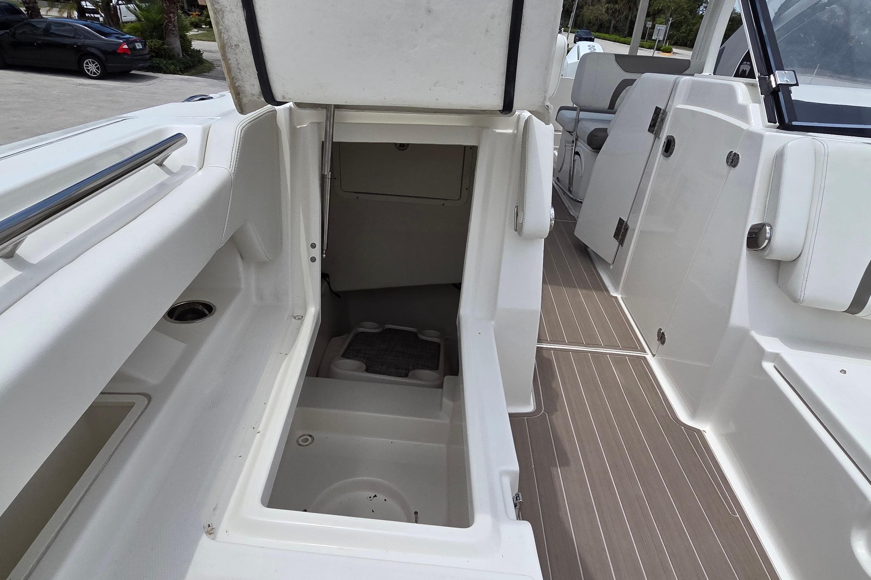 2023 World Cat 280 DC-X boat interior with open storage compartment and seating area.
