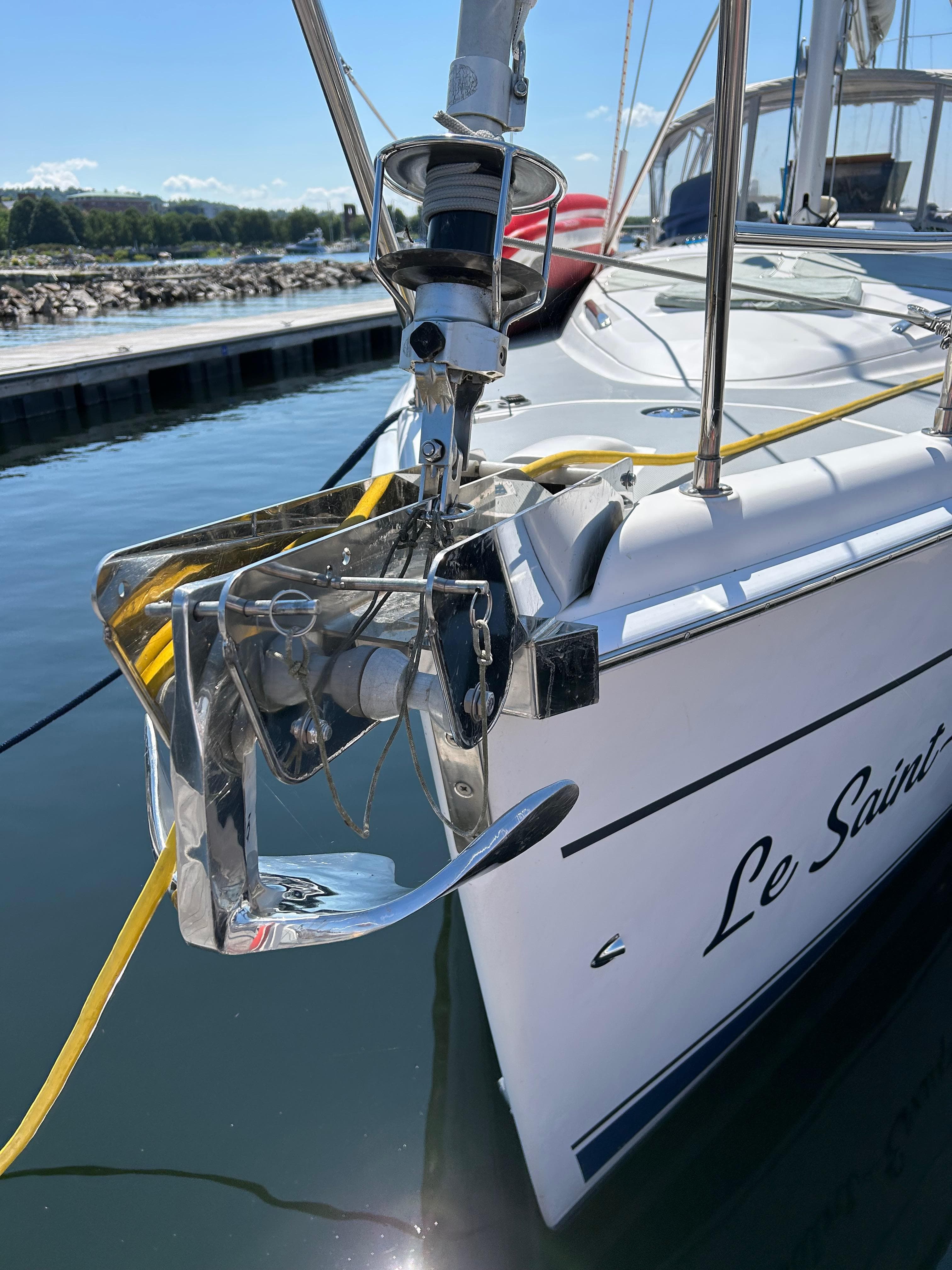 2003 Hunter 356 sailboat docked, featuring anchor and bow details.