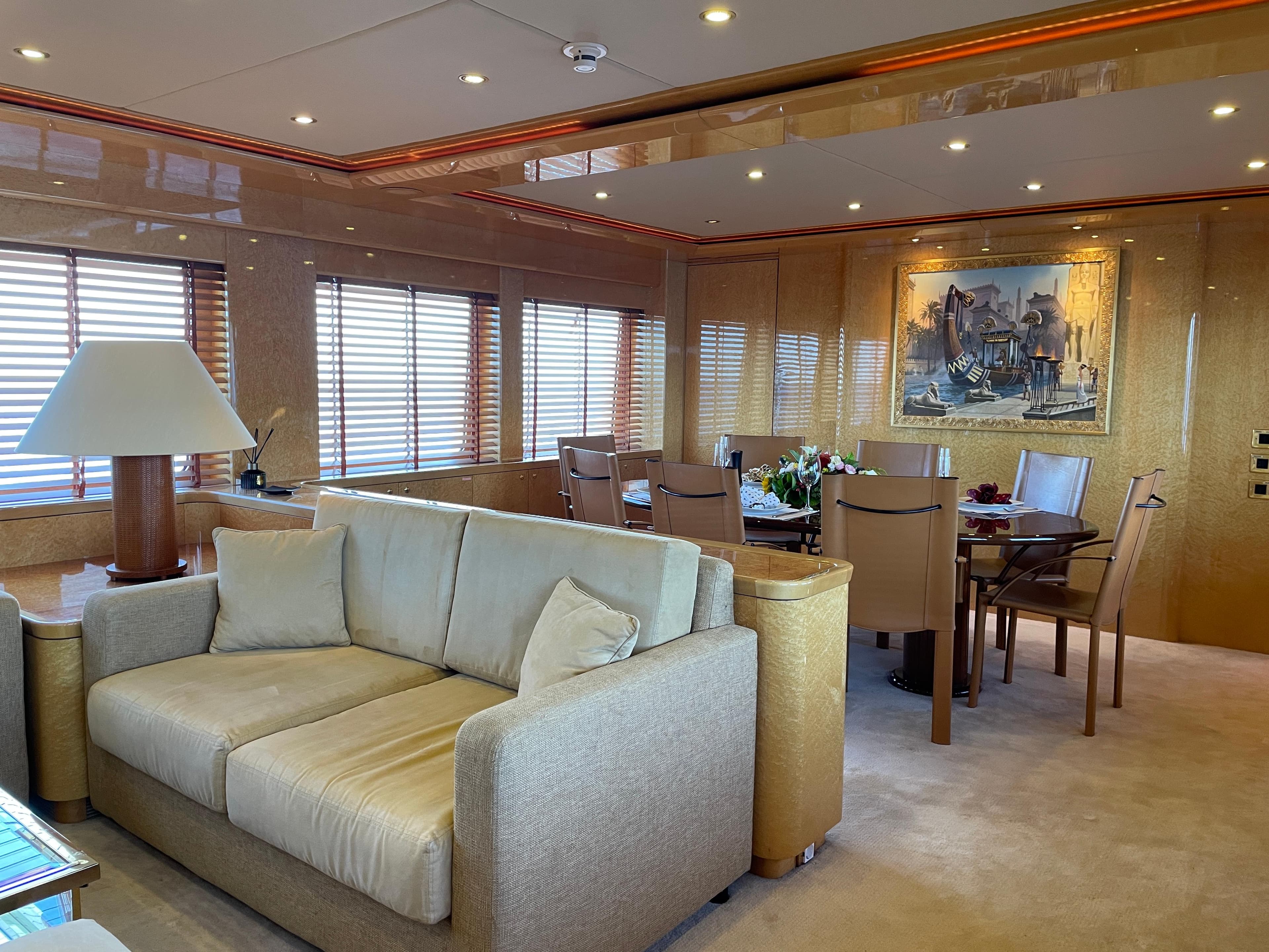 Luxurious interior of 2000 Heesen Versilcraft yacht with elegant seating and dining area.
