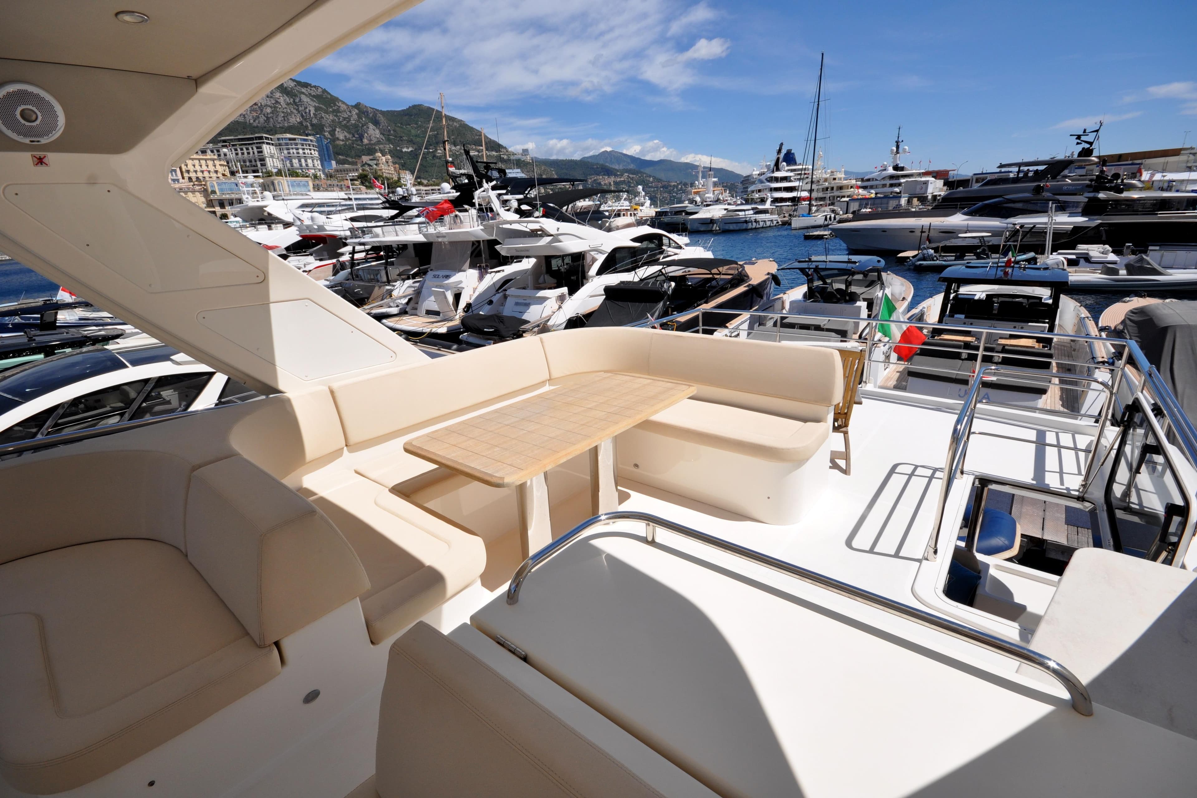 Luxurious 2018 Absolute Navetta 52 yacht docked in a bustling marina.