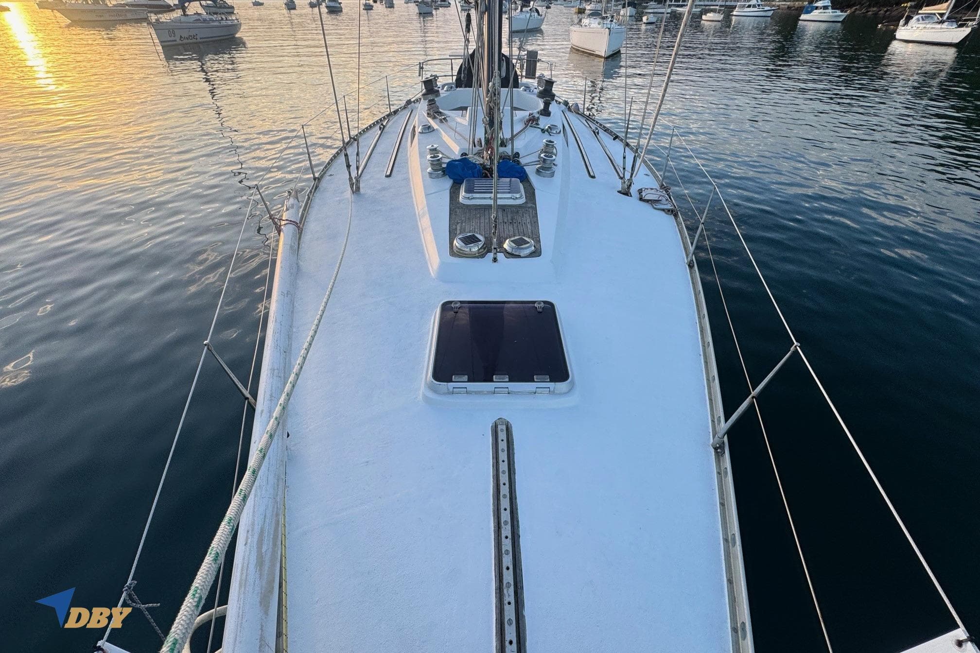 1981 Baltic 42 sailboat deck view at sunset, anchored in a calm harbor.