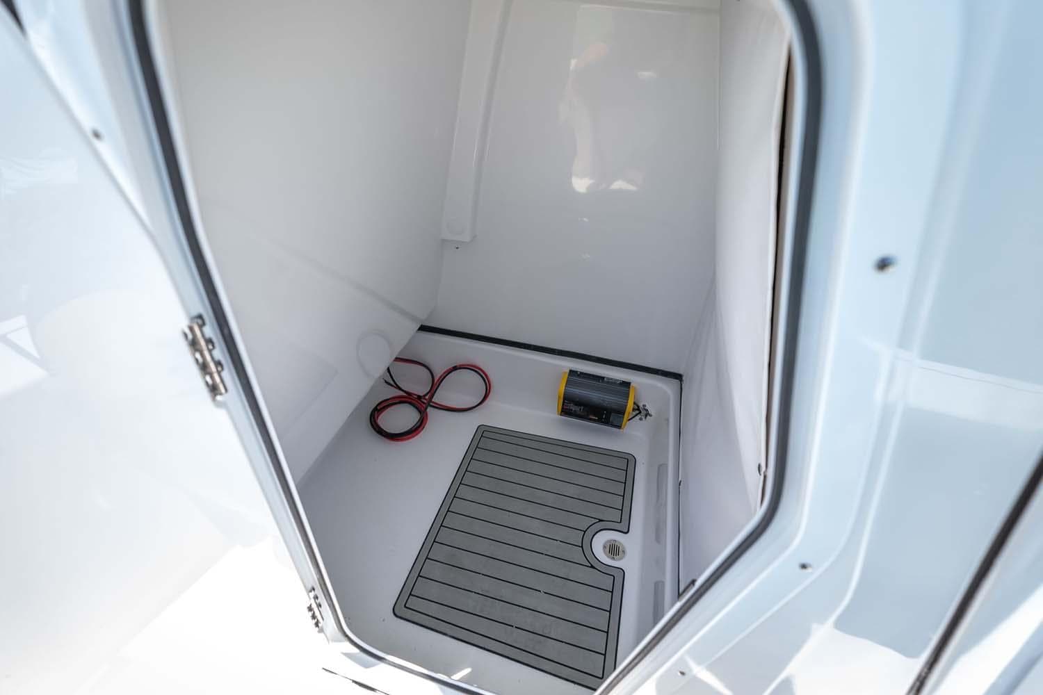 Manufacturer Provided Image: 2025 Sportsman Masters 247 Bay Boat storage compartment with mat and coiled rope.
