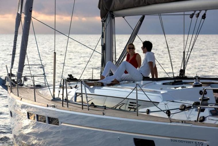 Manufacturer Provided Image: Couple relaxing on 2019 Jeanneau Sun Odyssey 519 sailboat at sunset.