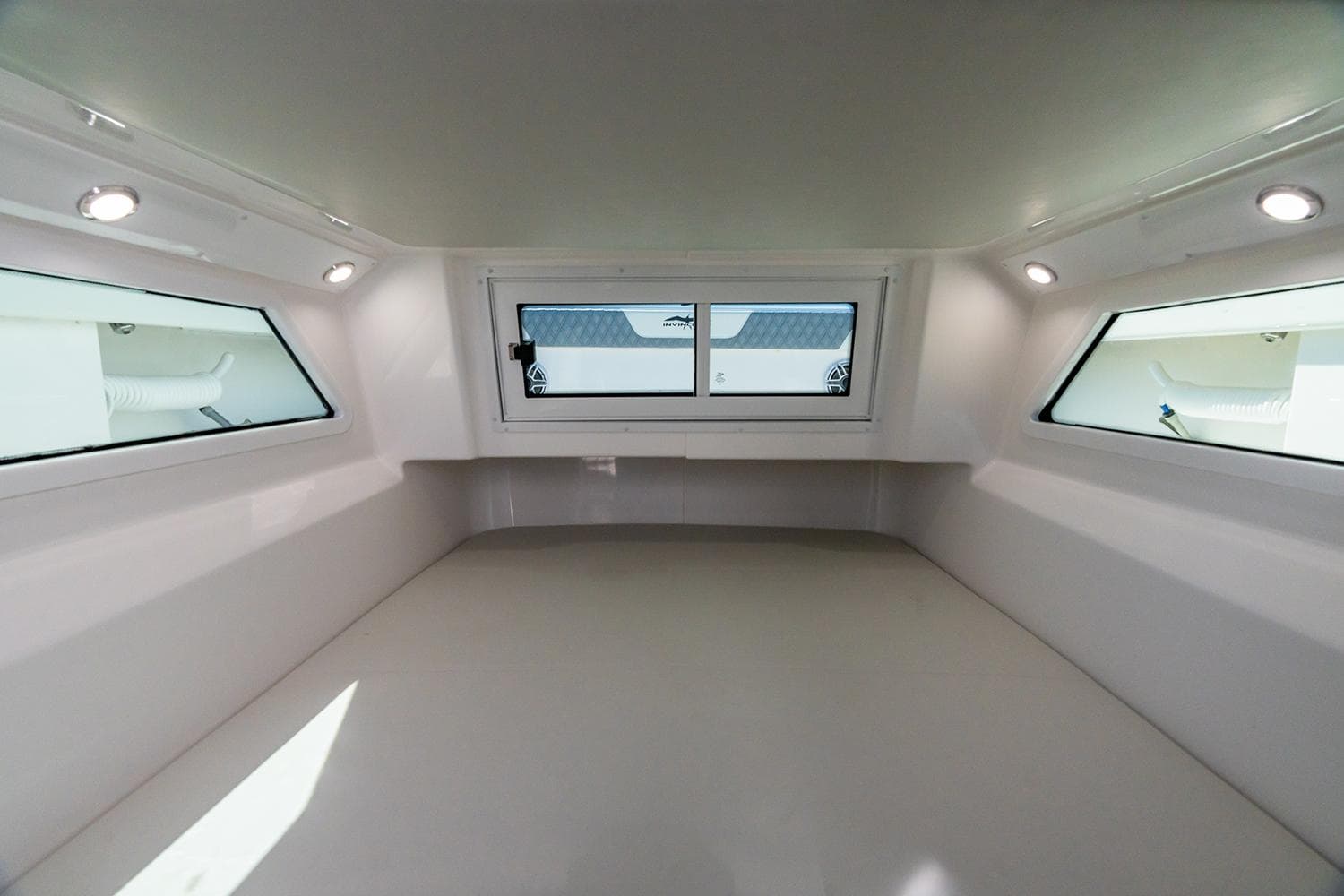 Manufacturer Provided Image: Interior cabin of 2026 Invincible 46 Pilothouse with windows and recessed lighting.