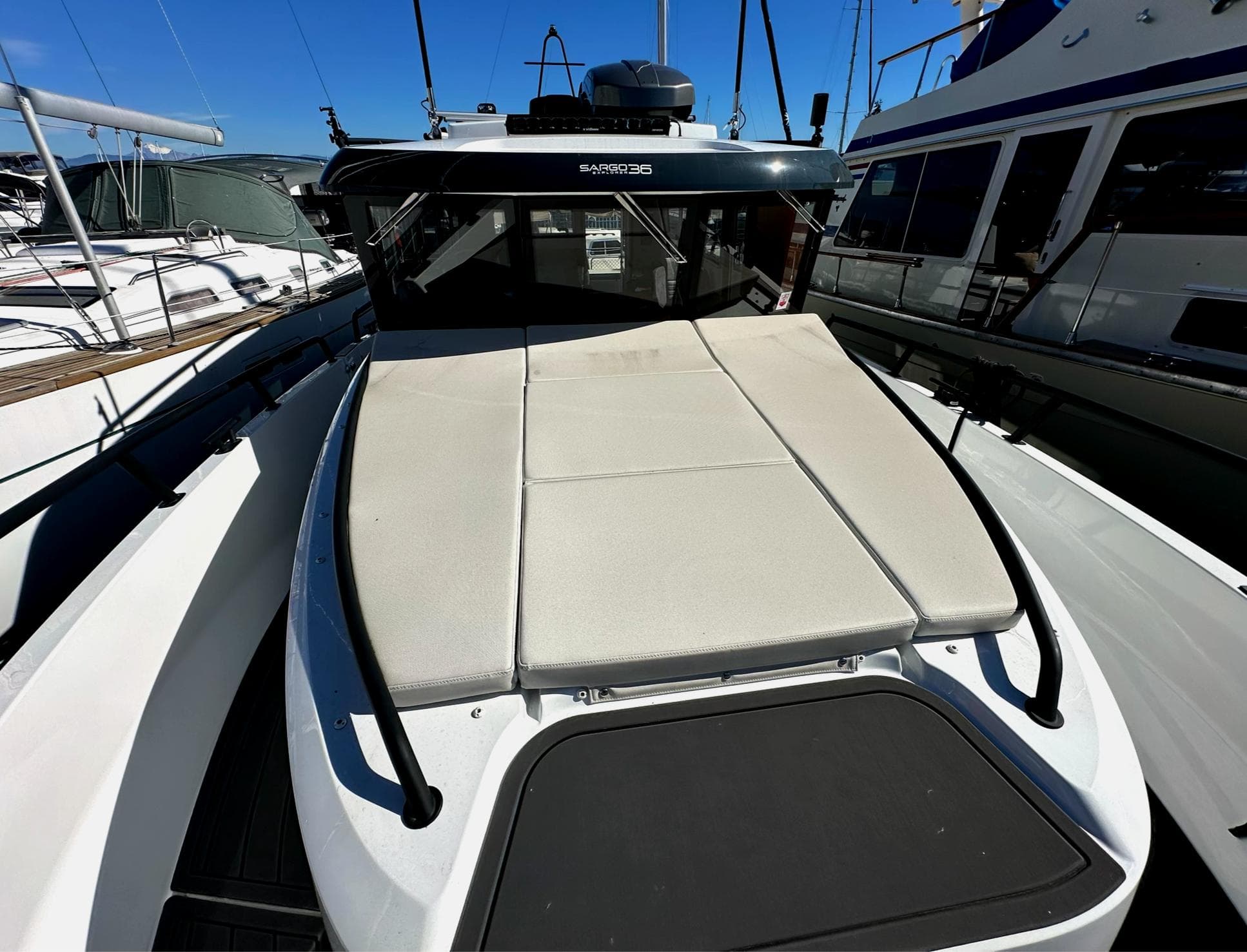 2024 Sargo 36 Explorer boat with sunbathing deck, docked at marina.