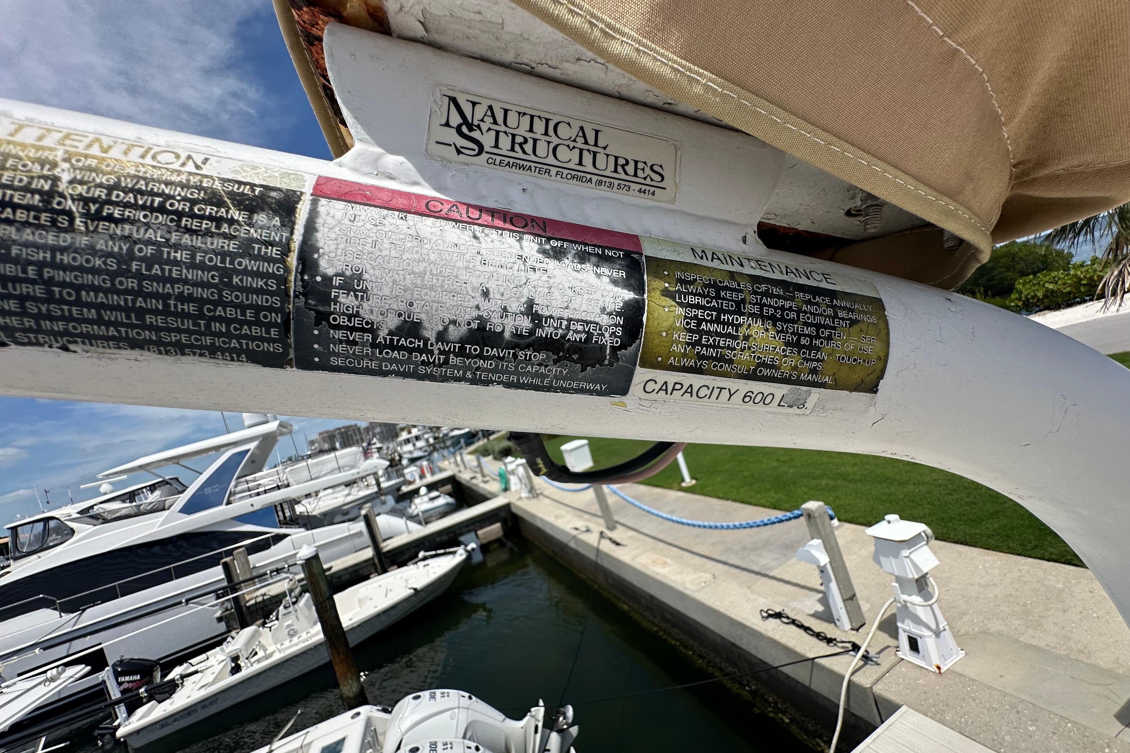 Boat davit with caution and maintenance labels, Kadey-Krogen Manatee 36, 1987 model.
