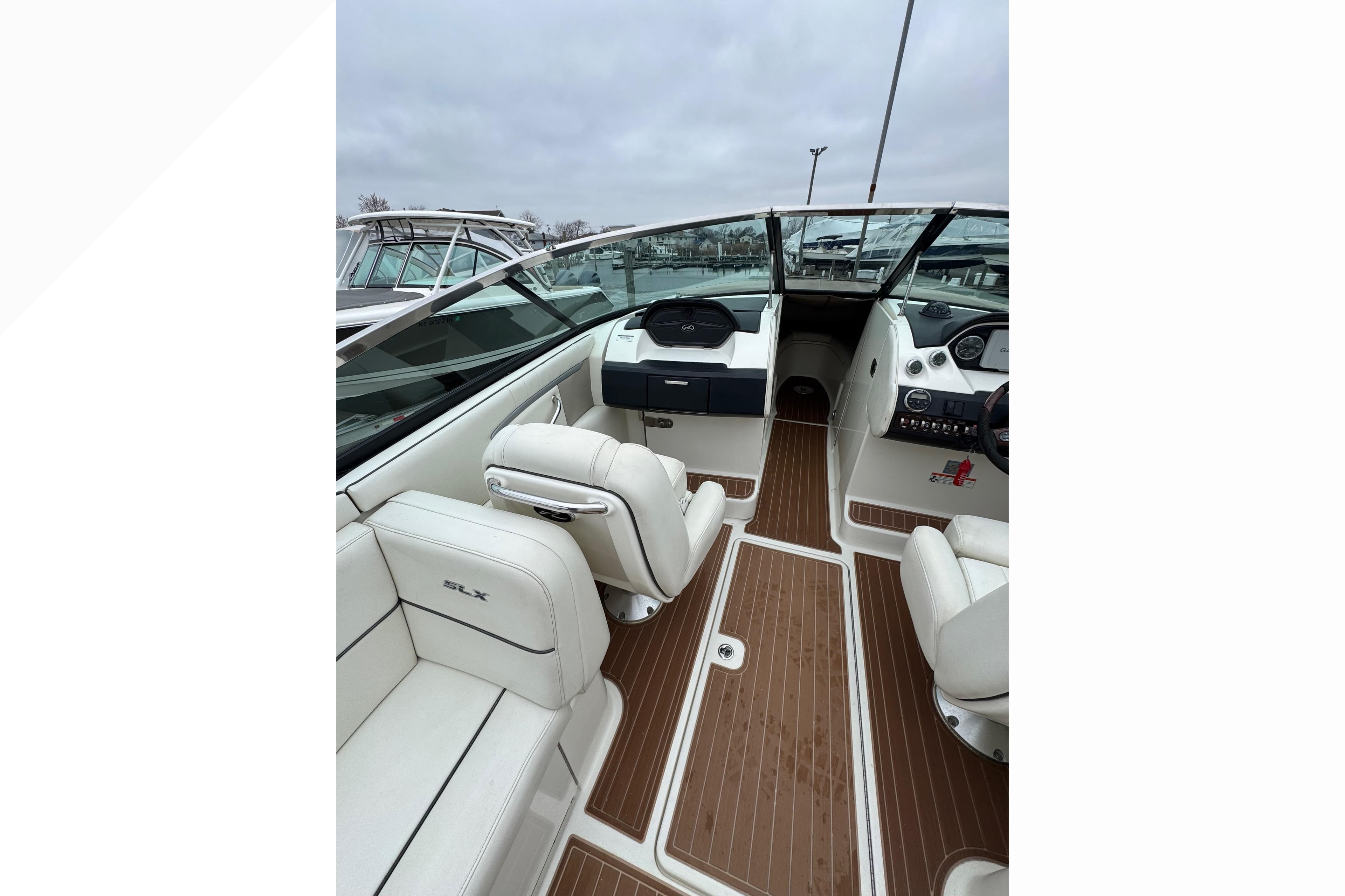 2007 Sea Ray 270 SLX boat interior with white seating and wood flooring.