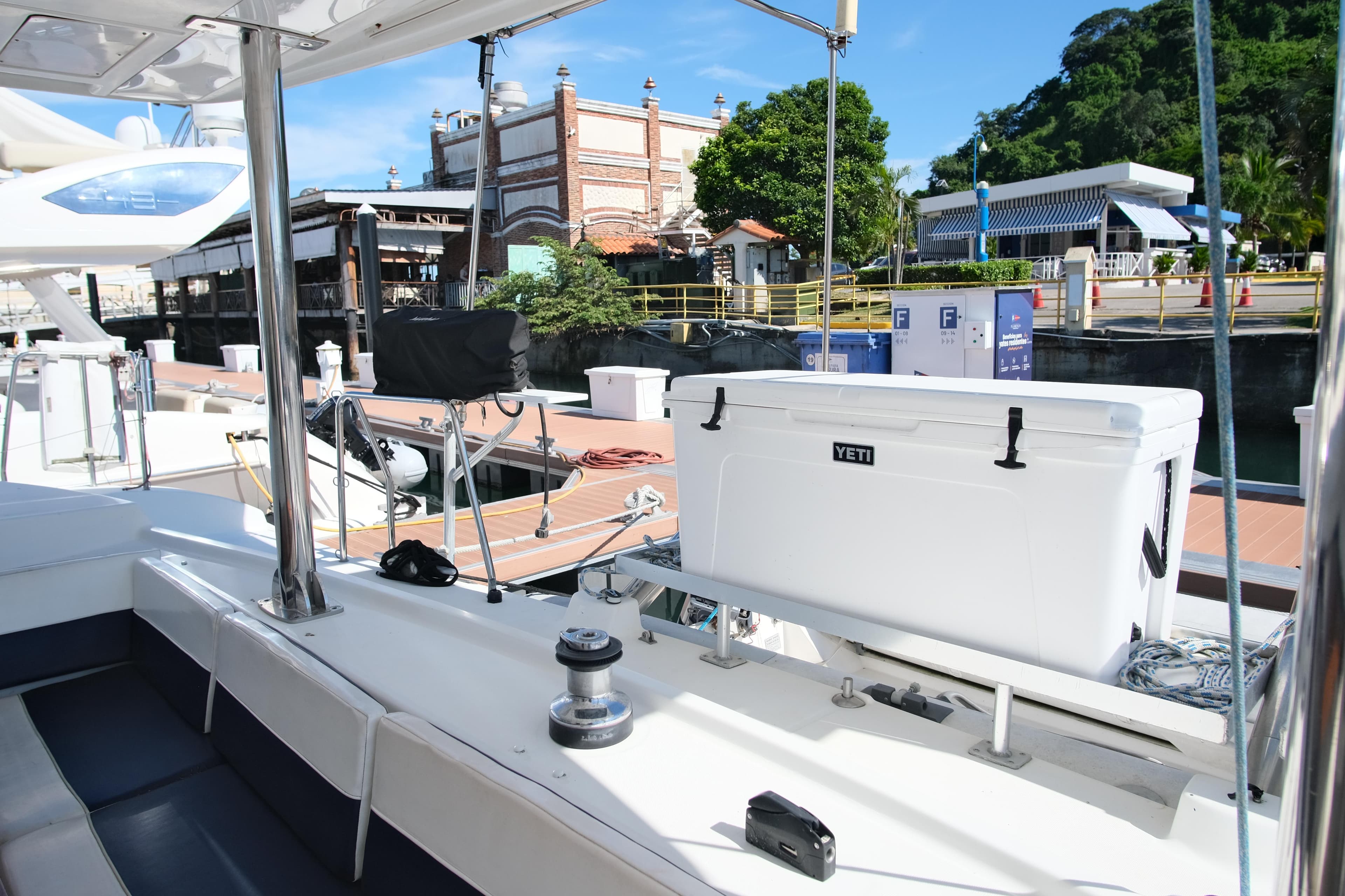 Lagoon 440 catamaran docked, featuring a Yeti cooler on deck, 2002 model.