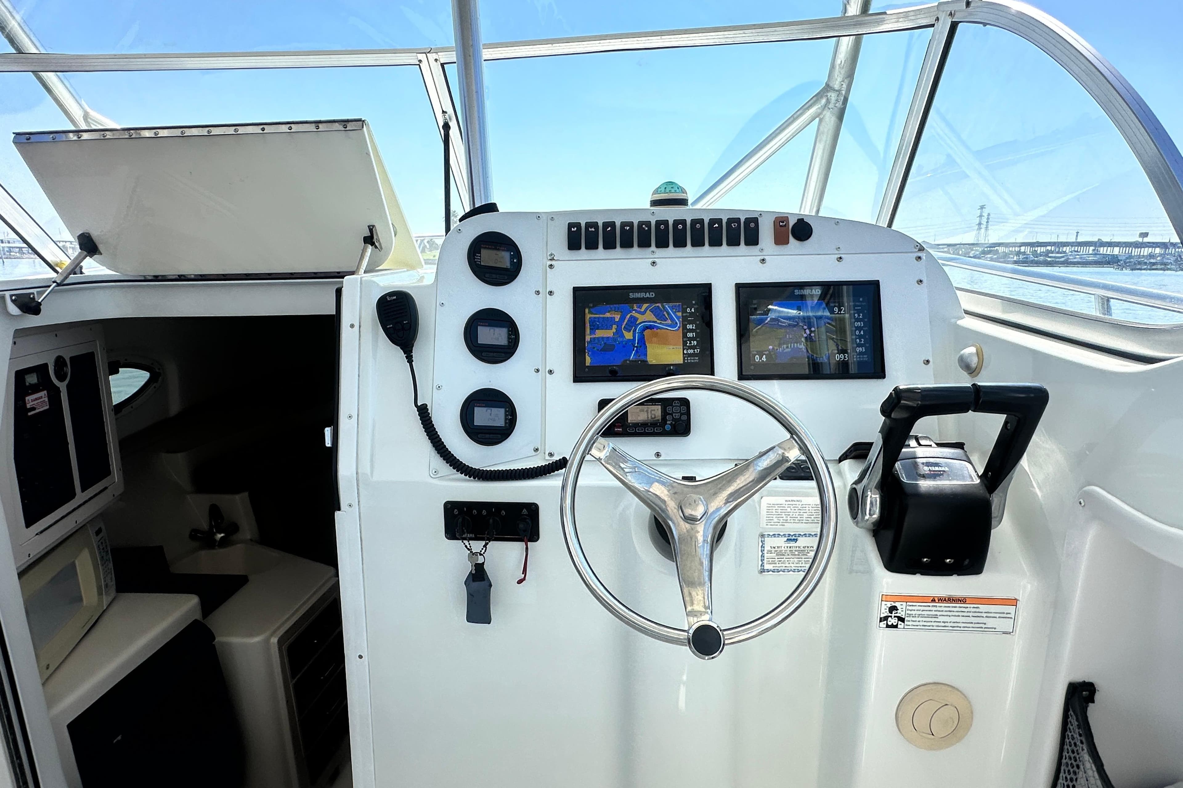 2007 Polar 2700 Walkaround boat helm with navigation screens and steering wheel.