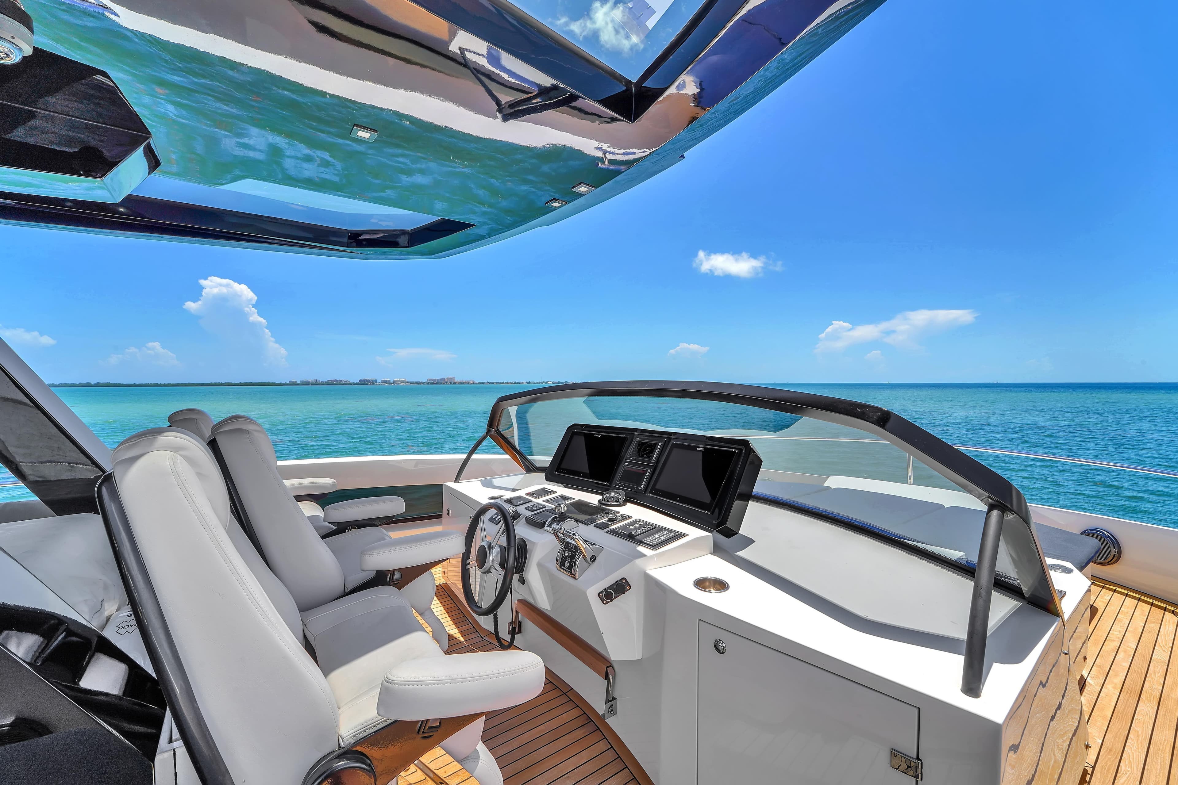 Luxurious 2021 OKEAN 80 yacht helm with ocean view and modern controls.