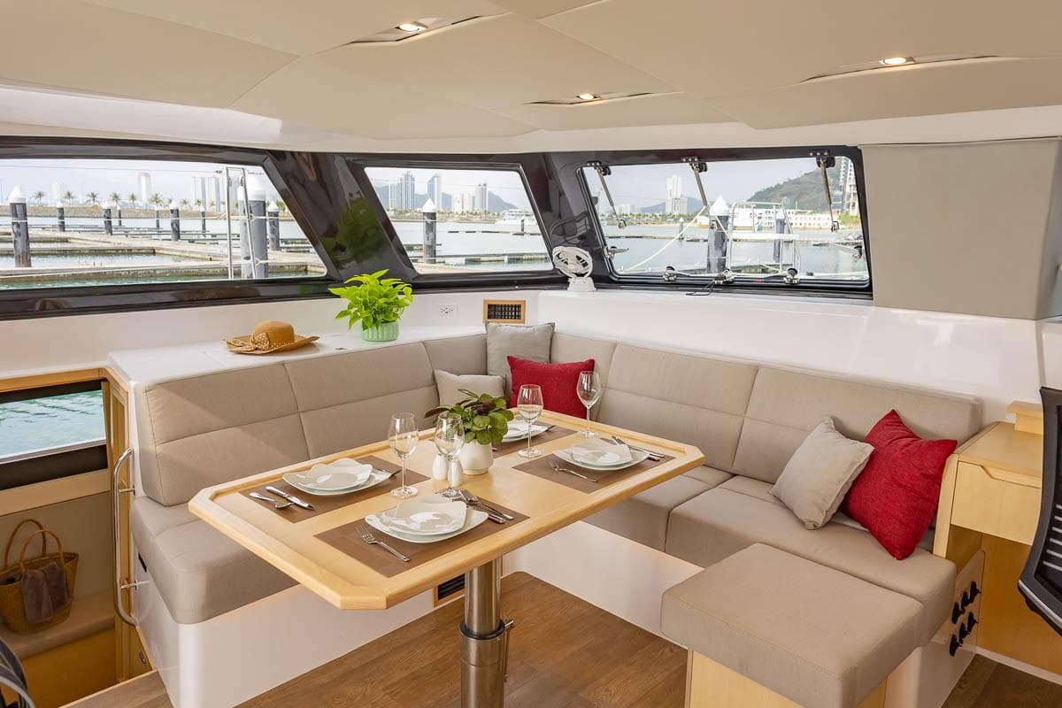 Luxurious interior of 2026 Seawind 1370 catamaran with elegant dining area and scenic views.