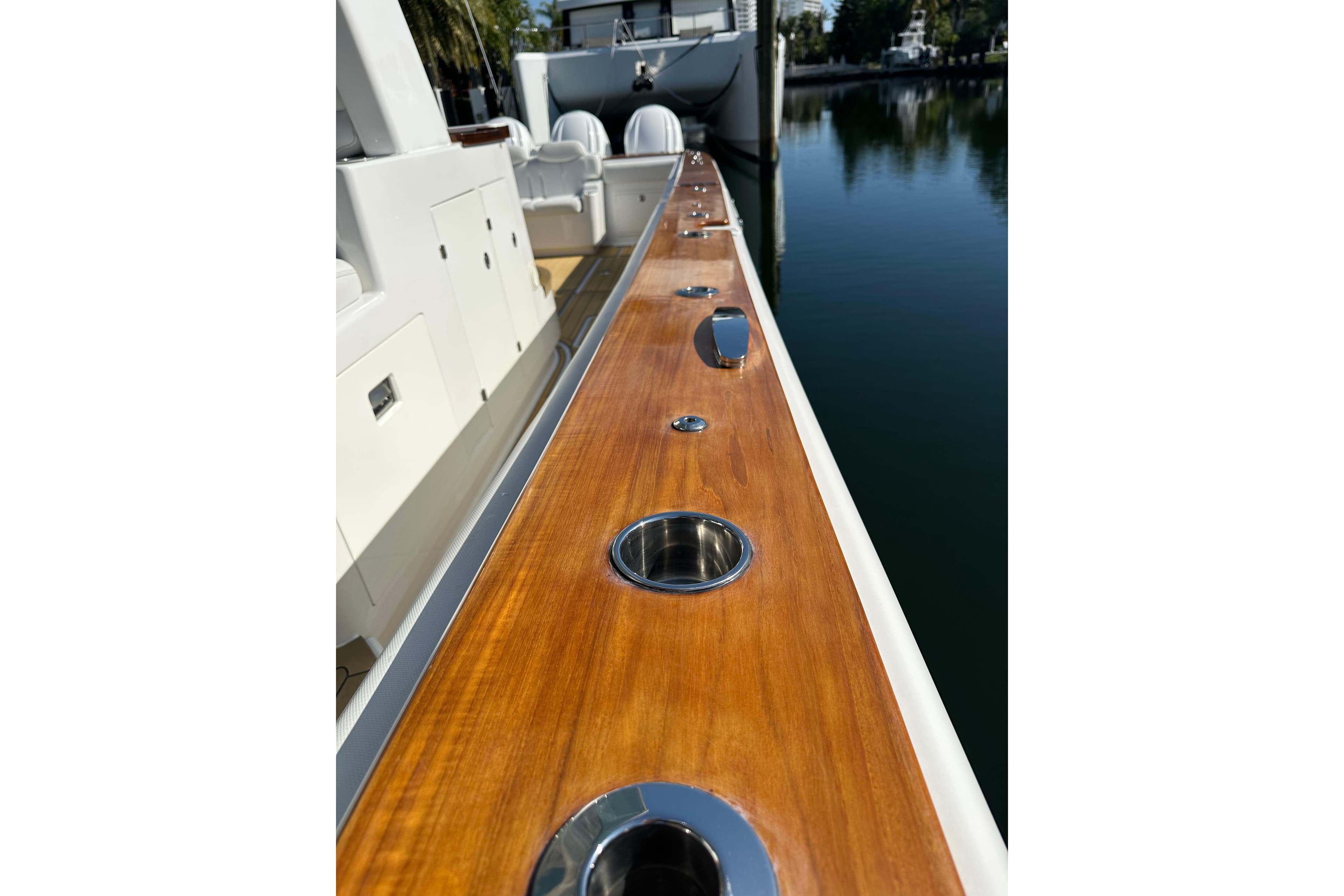 2021 HCB 65 Estrella yacht deck with polished wood and stainless steel fixtures.