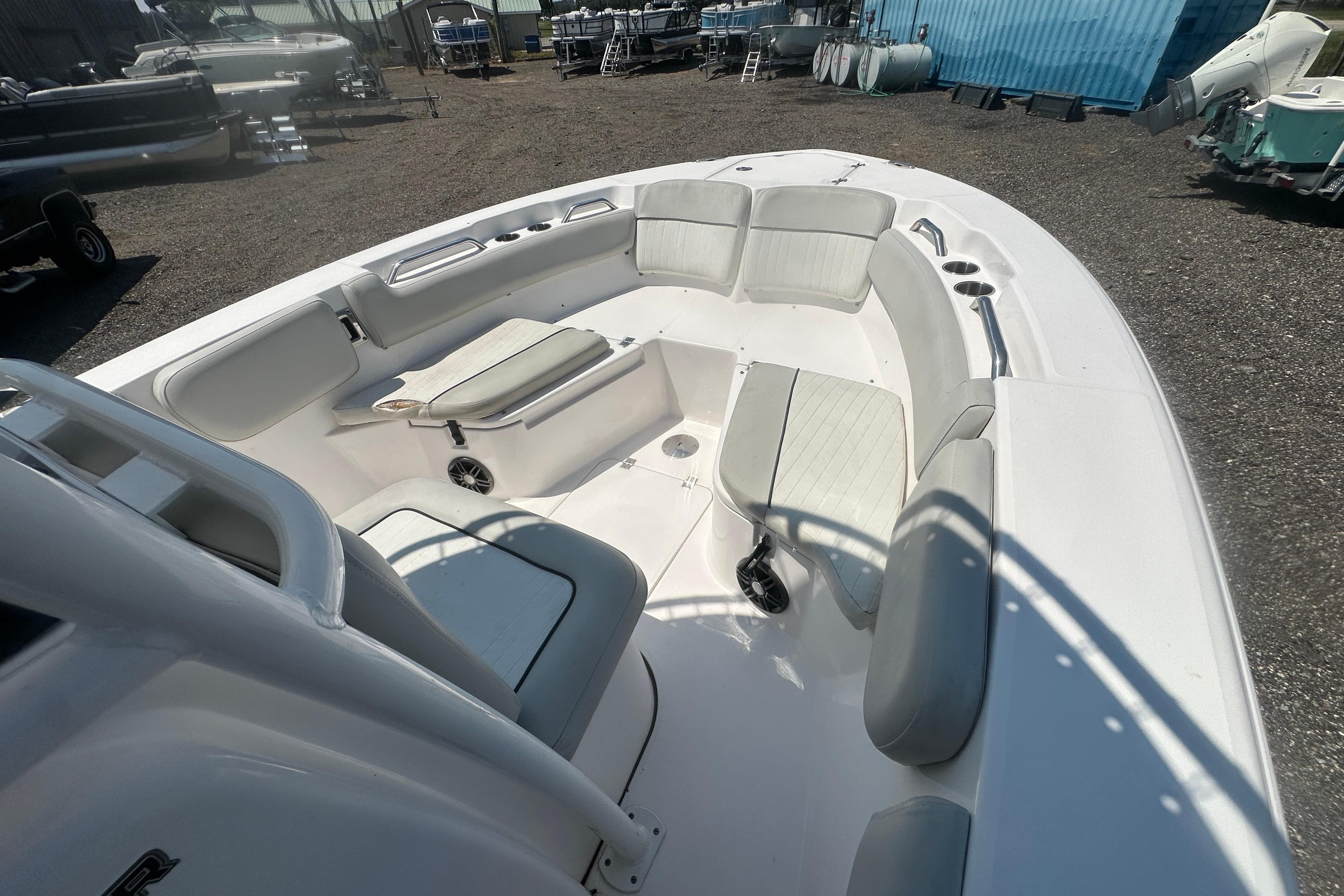 2023 Sea Fox 228 Commander boat interior with cushioned seating and cup holders.