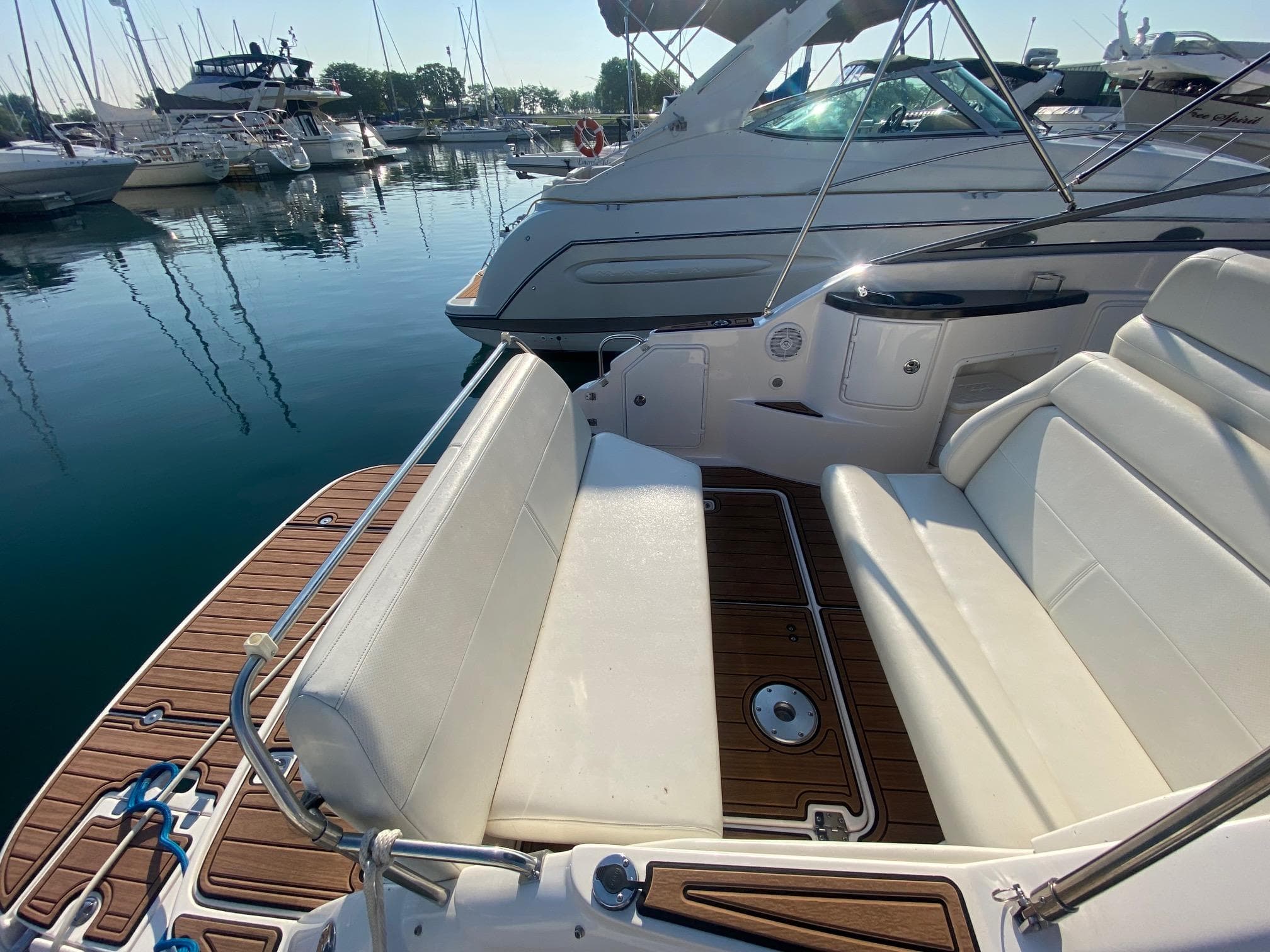 2004 Regal 2665 Commodore boat with white seating at a marina.