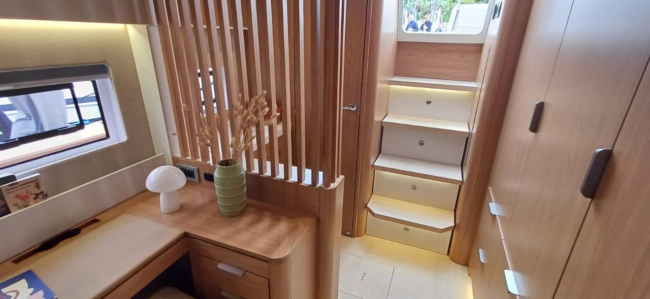 Luxurious interior of 2025 Bali 5.8 yacht with modern wooden decor and elegant staircase.