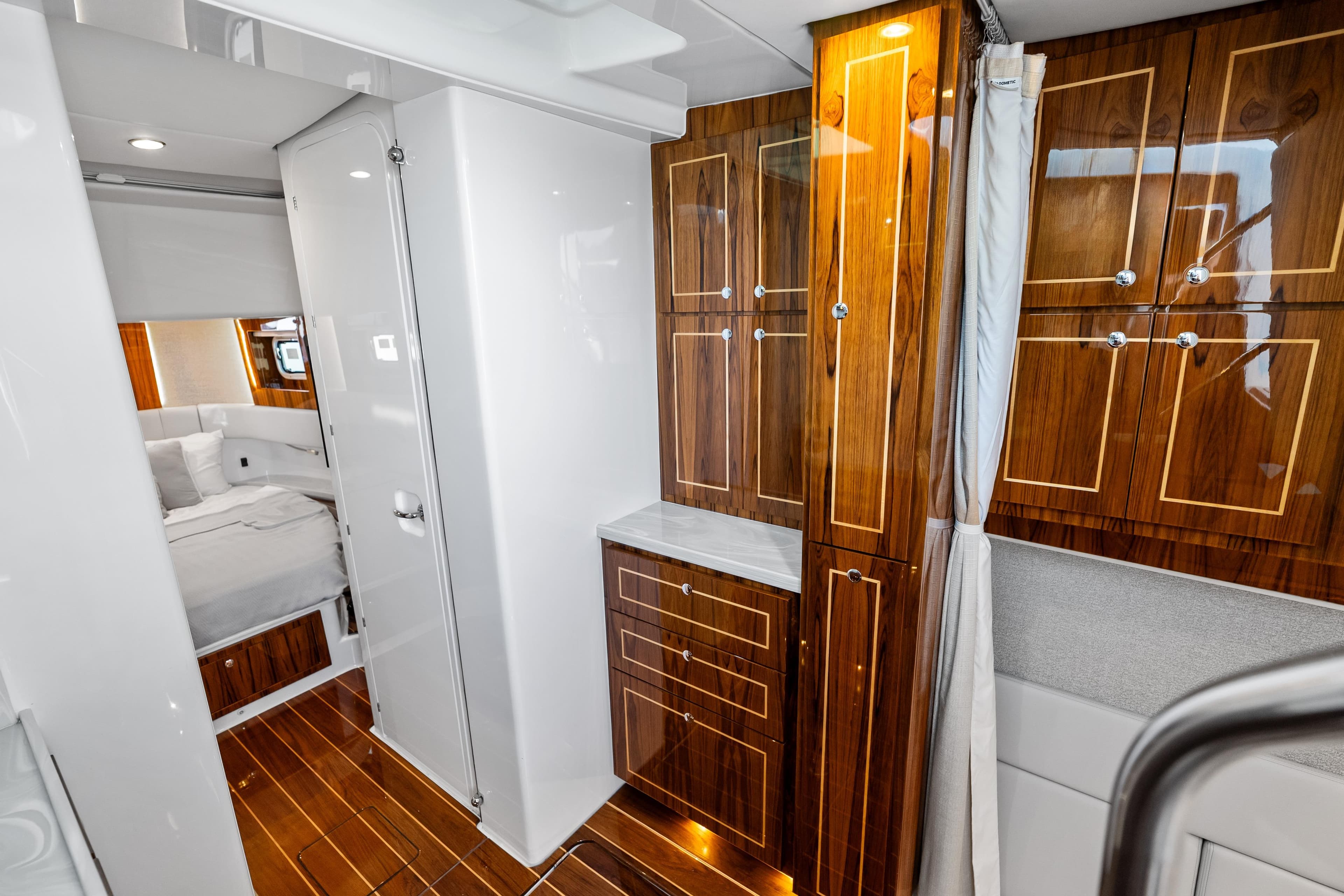 Luxurious interior of 2025 HCB 56 Suenos GIX yacht with elegant wood cabinetry.