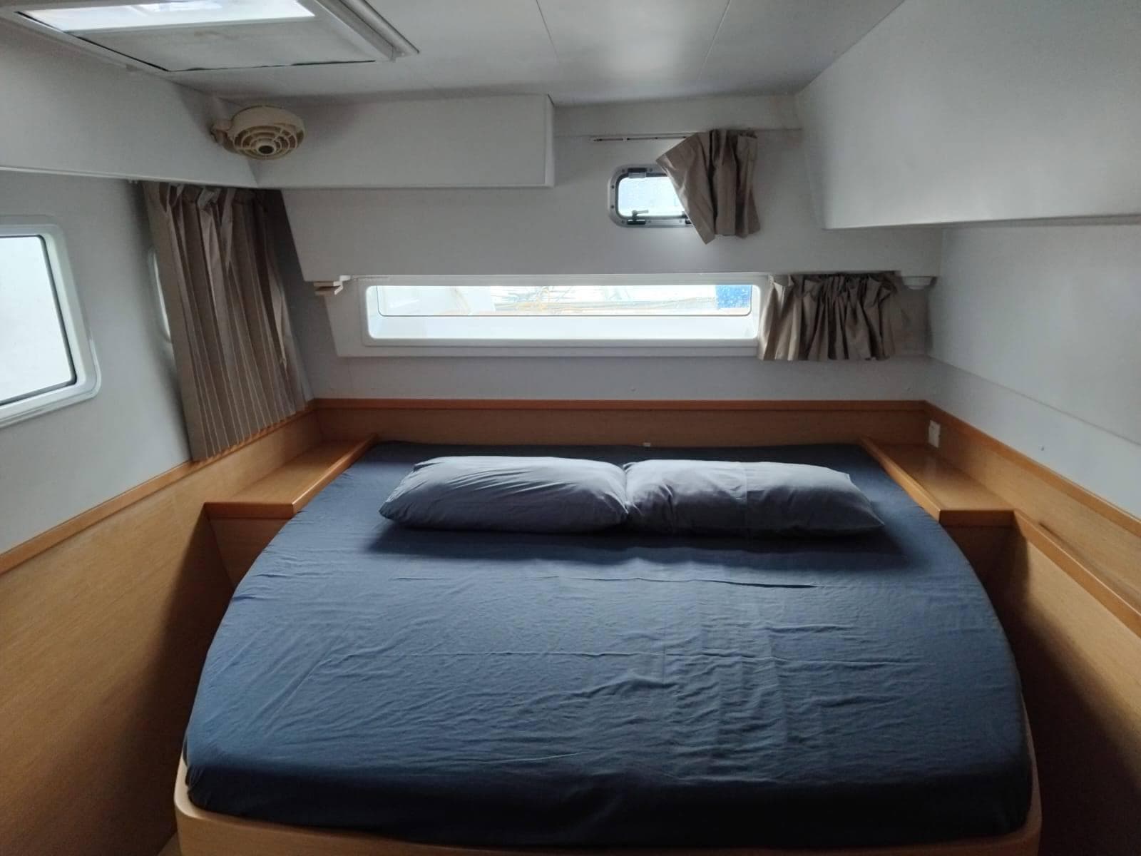 Cozy cabin interior of 2017 Lagoon 42 catamaran with a neatly made bed.
