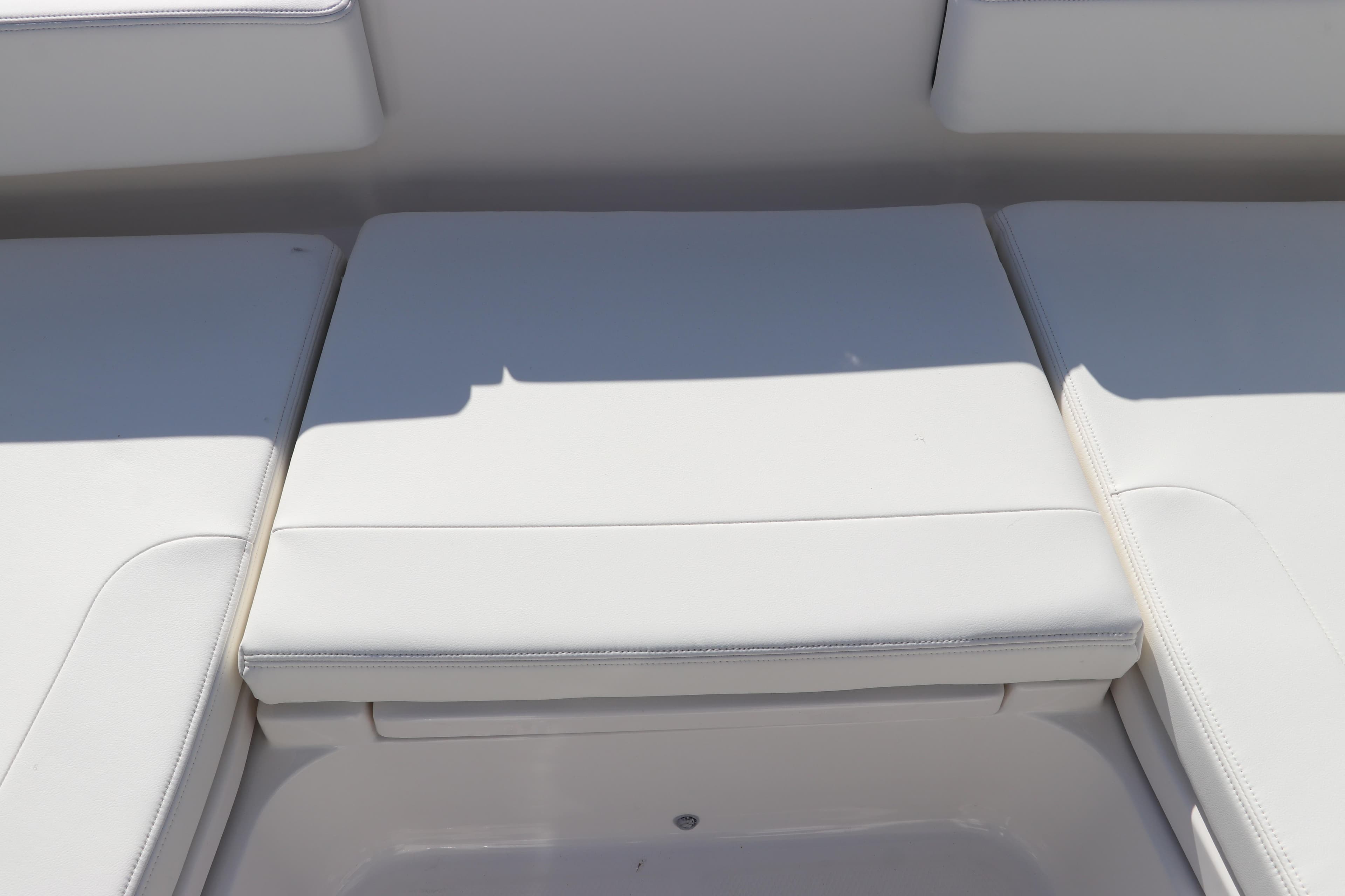 2024 Robalo 266 Cayman boat seating area with white cushions.