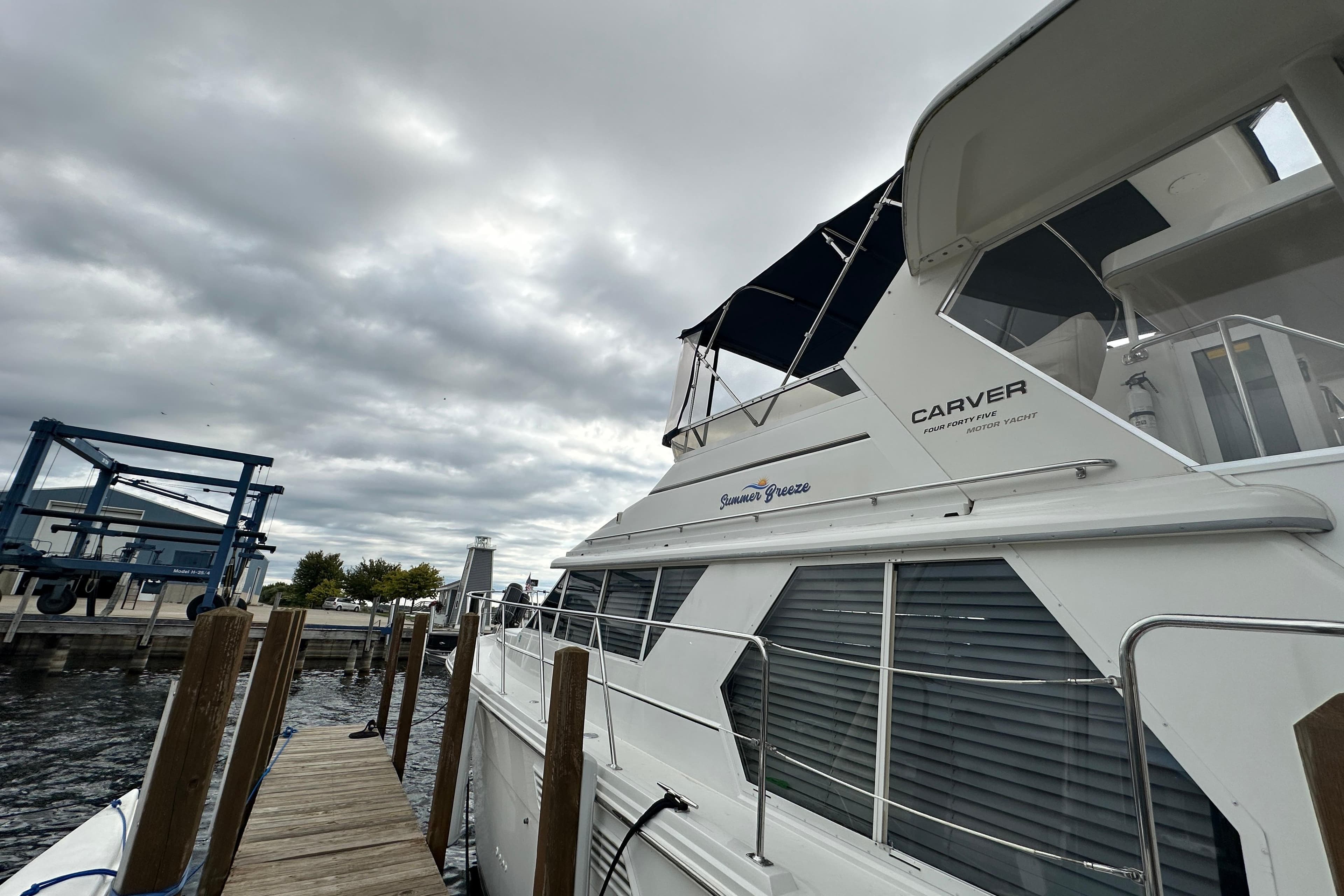 1998 Carver 445 Aft Cabin Motor Yacht docked under cloudy skies.