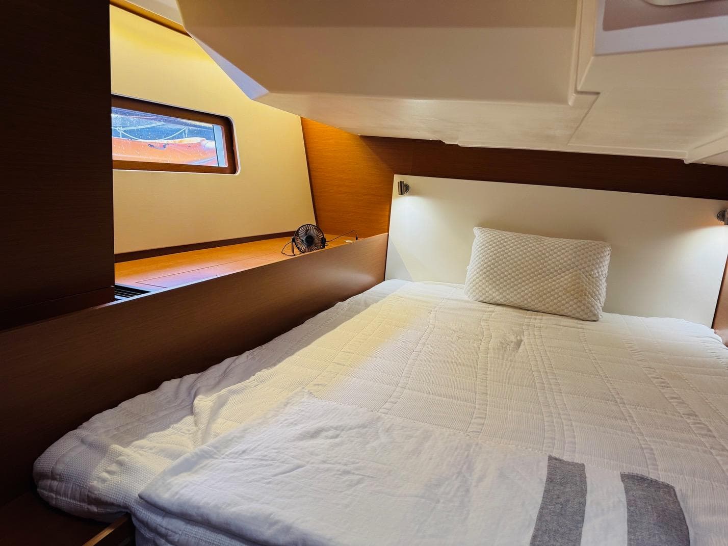 Cozy cabin interior of 2020 Beneteau Oceanis 51.1 yacht with comfortable bedding.