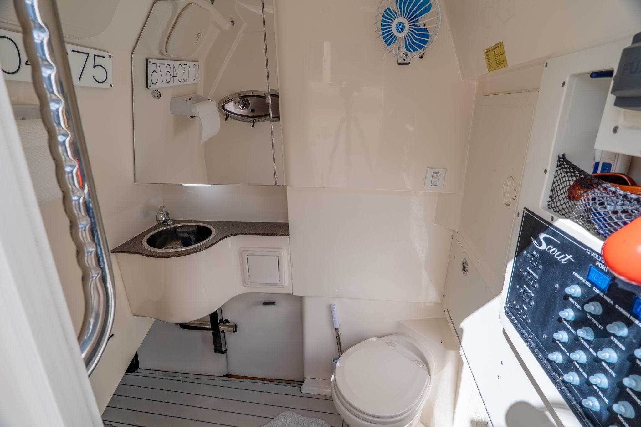 2019 Scout 320 LXF boat interior with sink, toilet, and control panel.