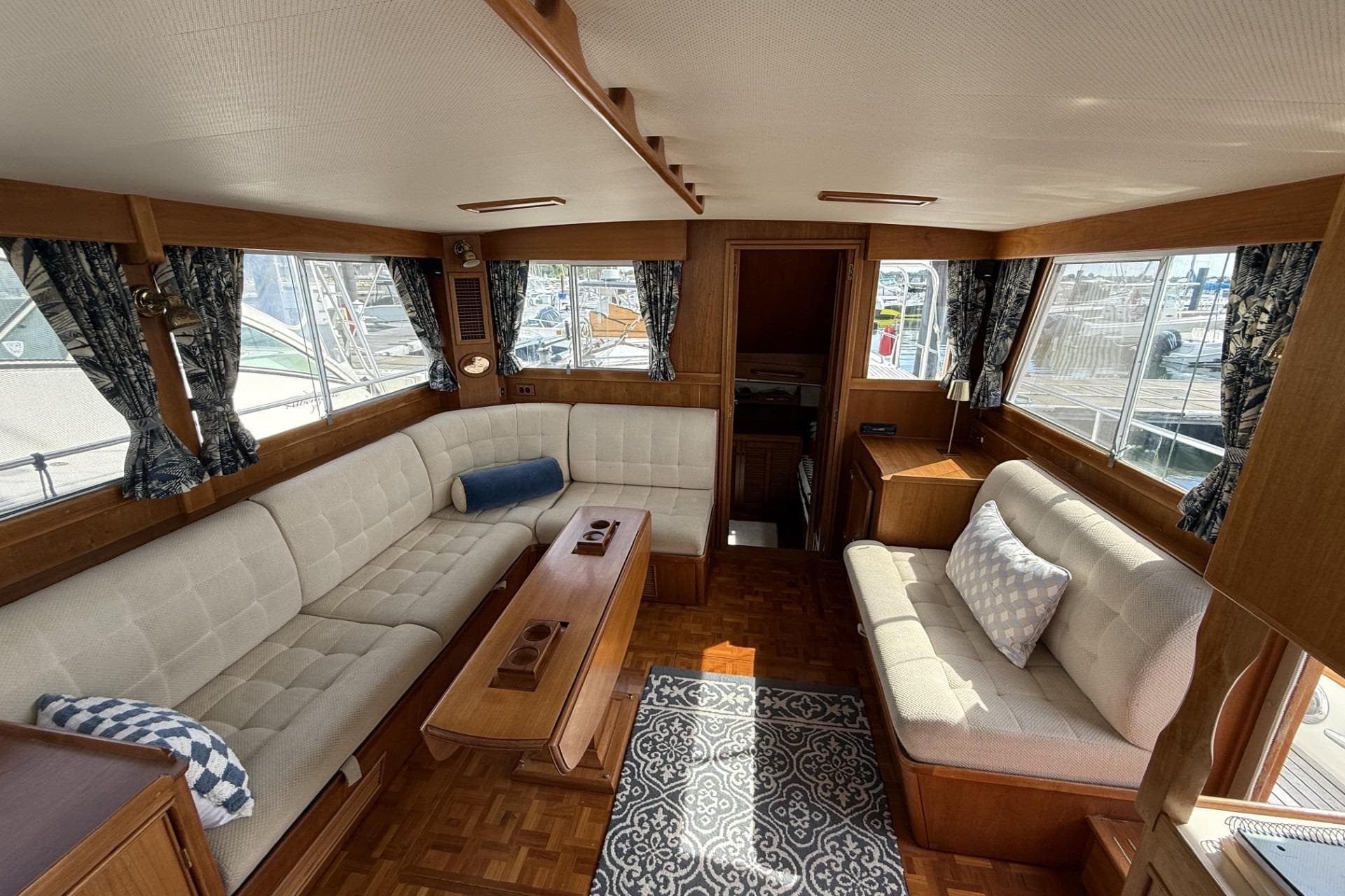Interior of 1999 Grand Banks 42 Classic yacht with elegant seating and wooden accents.