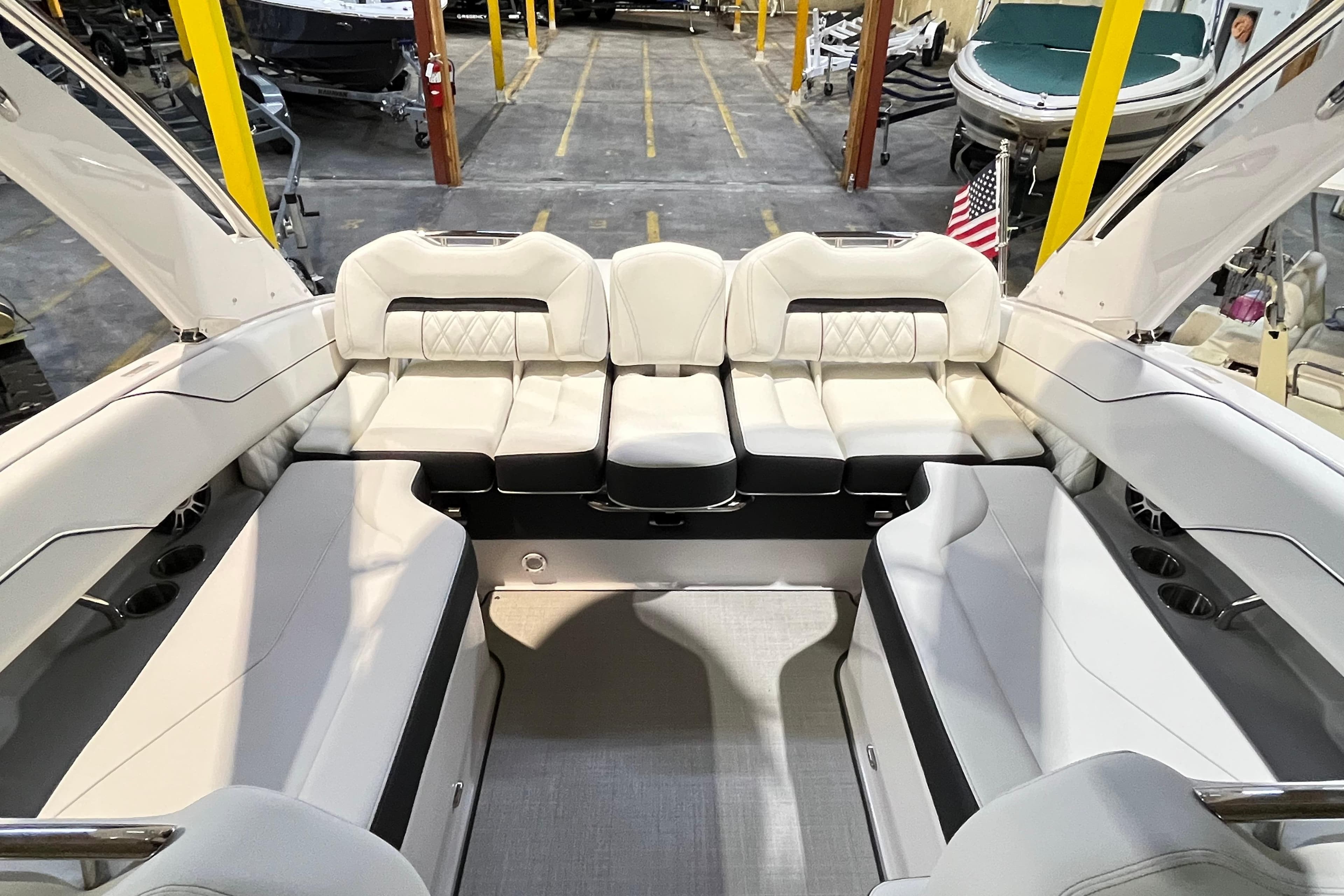 2025 Regal LS4 boat interior with luxurious white seating in a showroom.