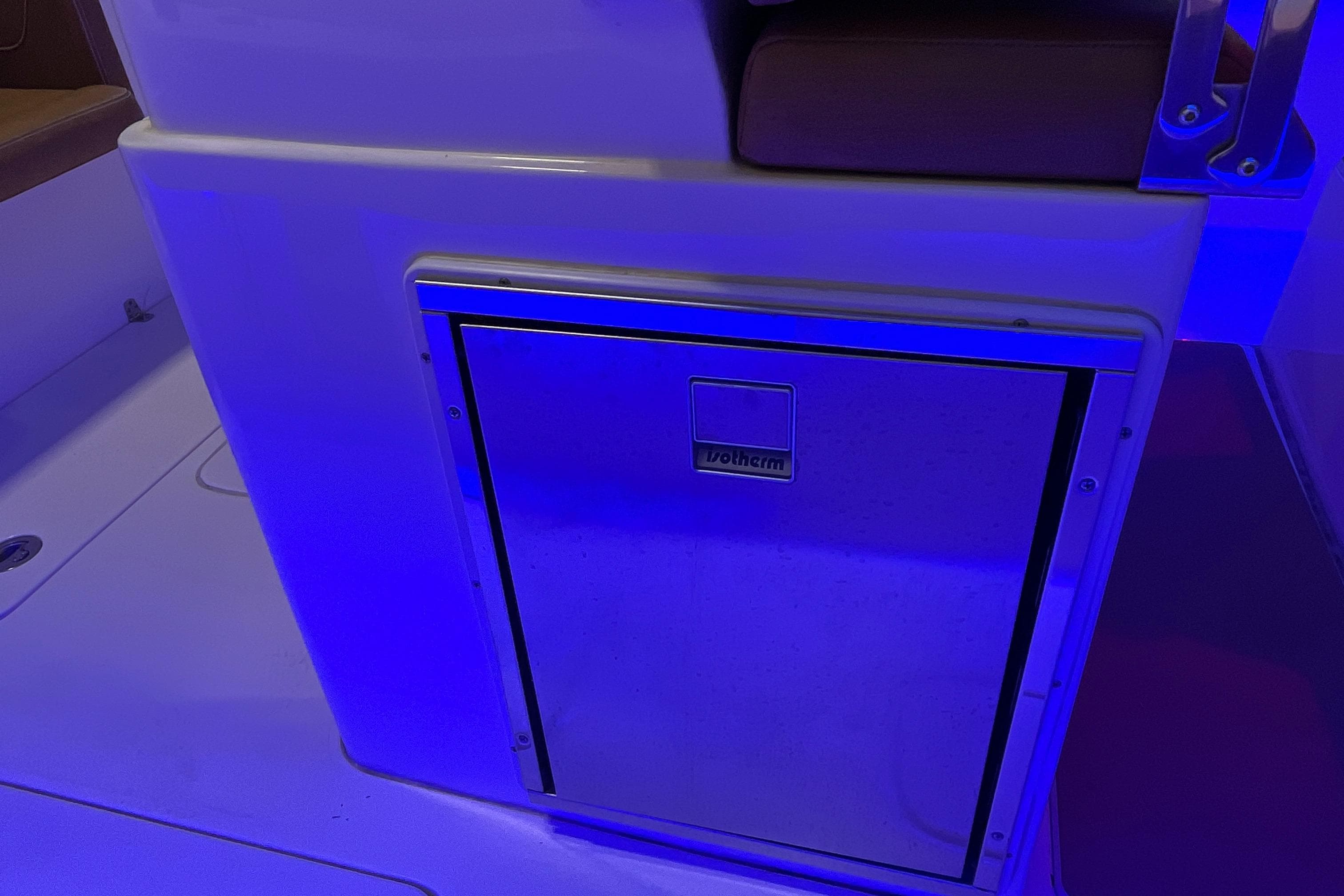 2021 Scout 305 LXF boat interior with blue-lit storage compartment.