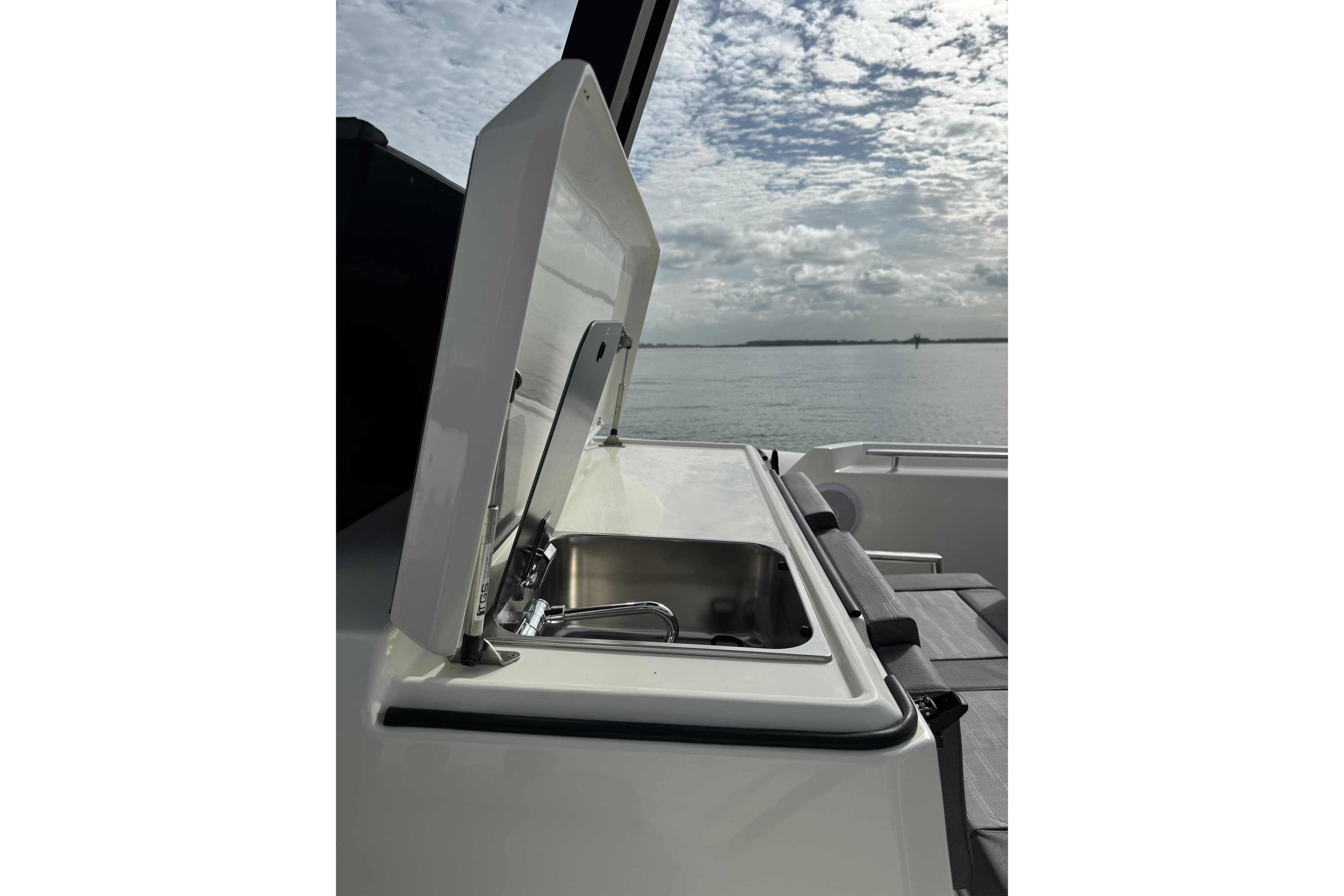 2026 Northstar ORION 10 boat with open sink, ocean view, and cloudy sky.