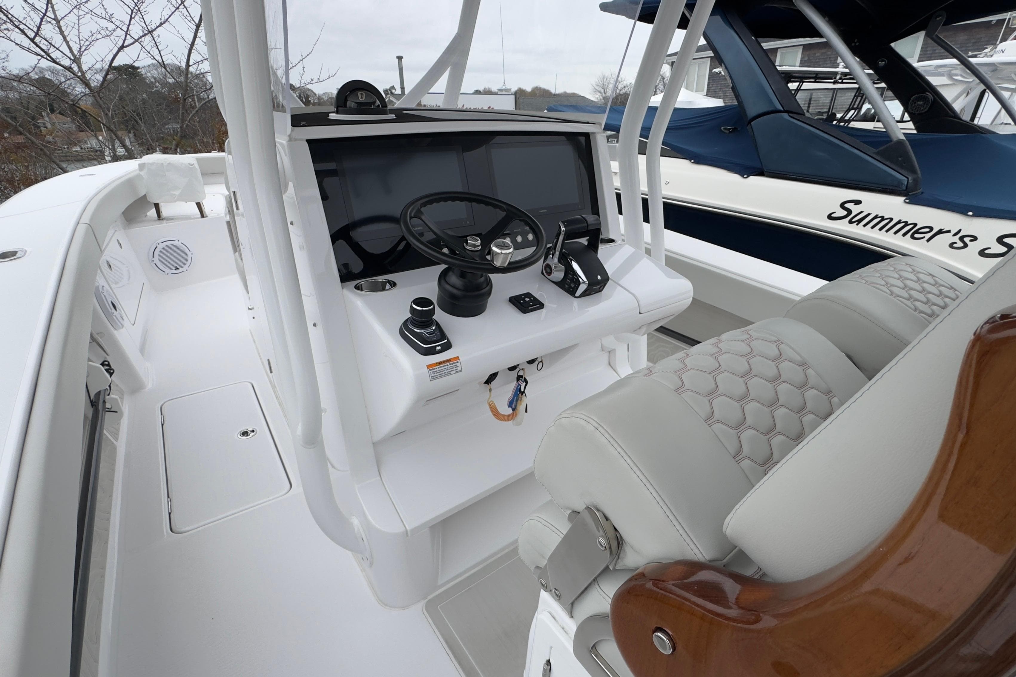 2024 Jupiter 32 FS boat cockpit with modern steering and controls.