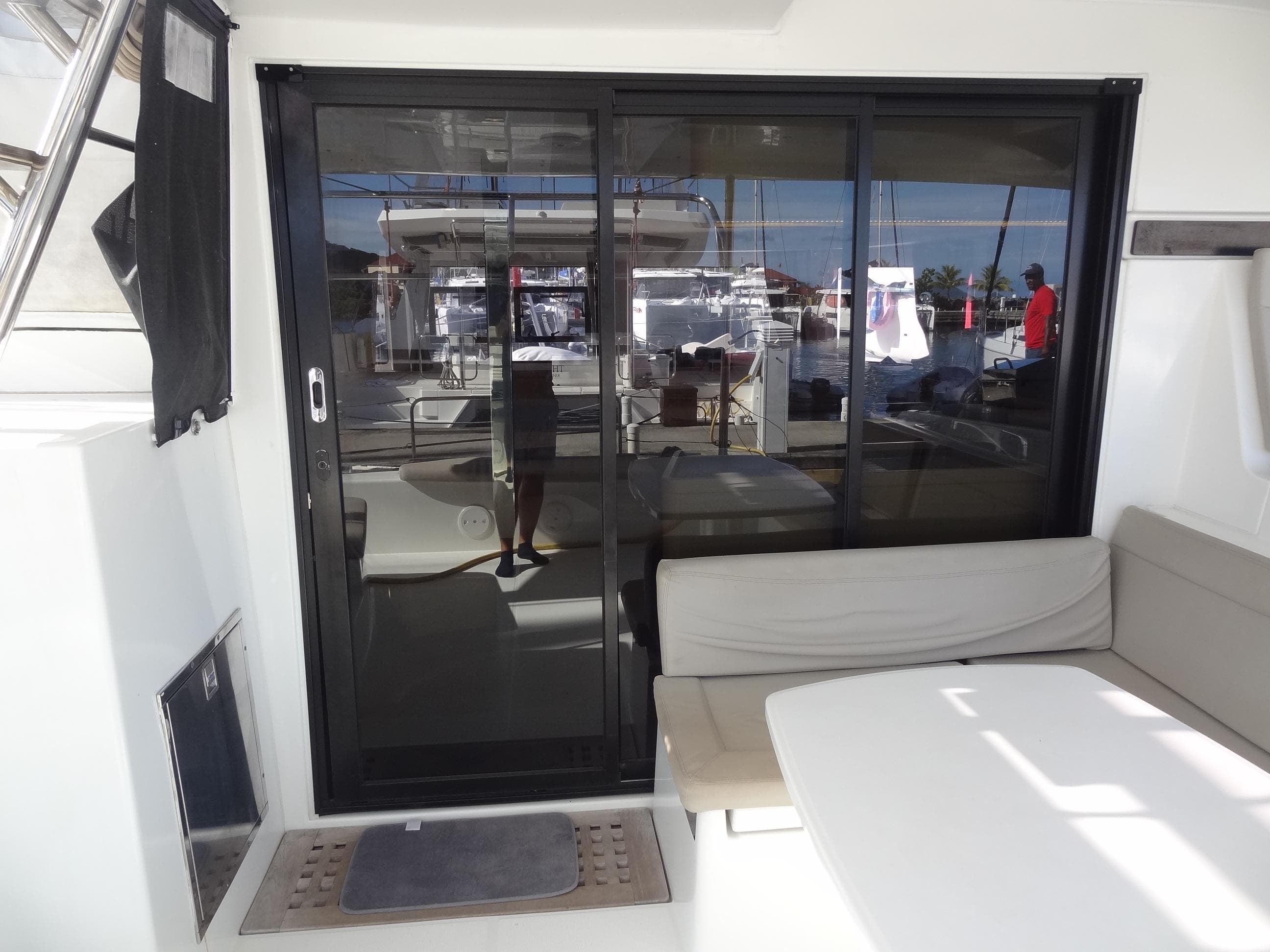 Lagoon 42 catamaran 2020 model with sliding glass doors and outdoor seating area.