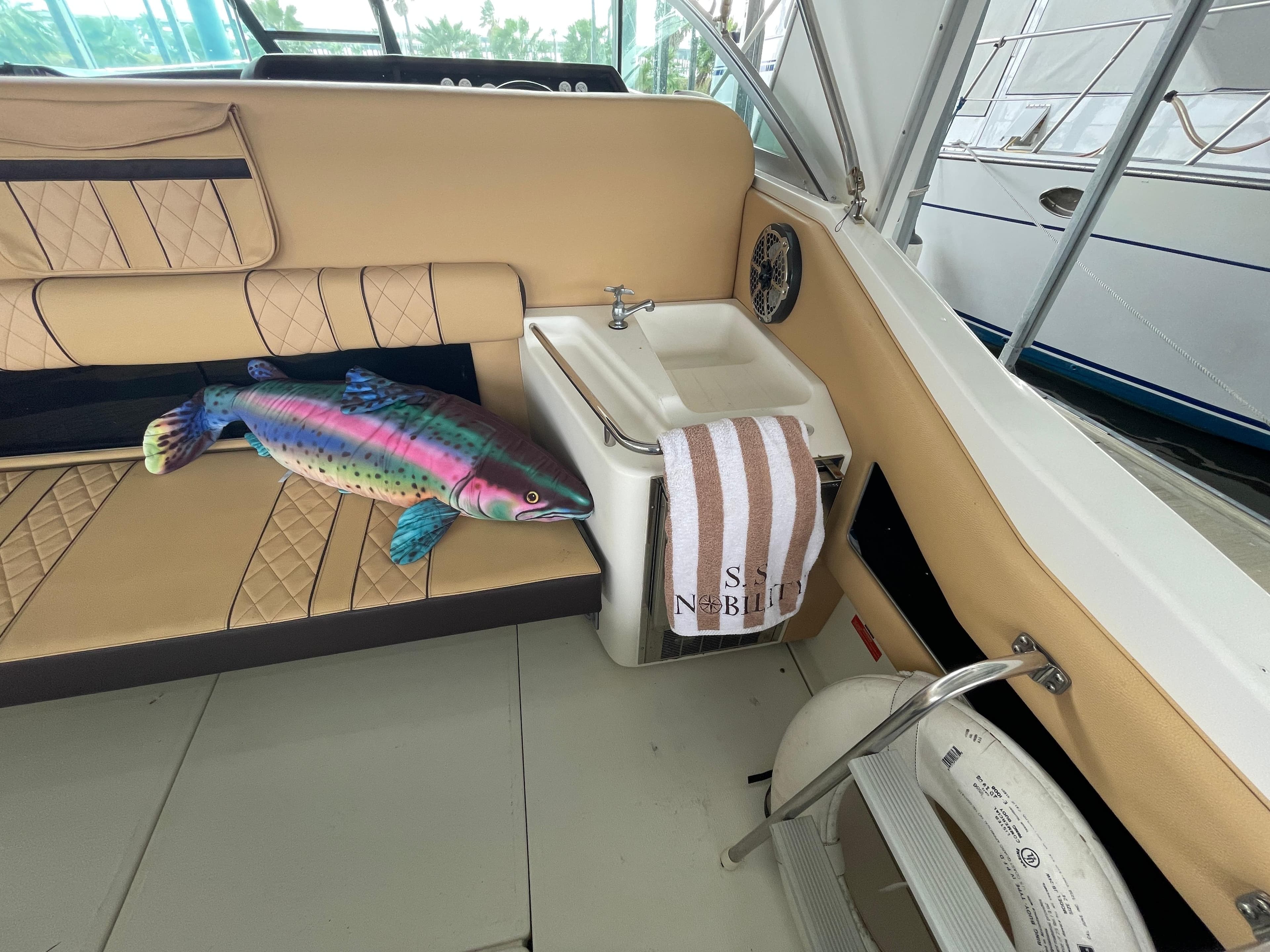 1993 Sea Ray 370 Sundancer interior with plush seating and colorful fish decor.